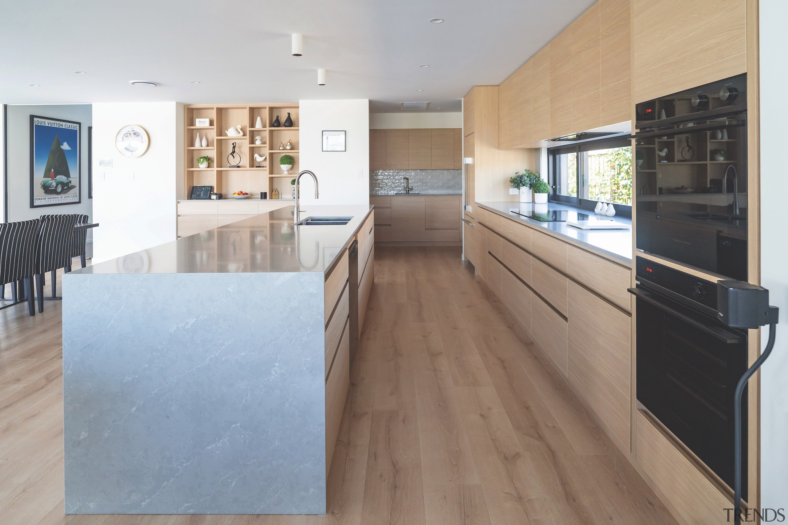 Expansive kitchen with modern island and sleek handle-free 