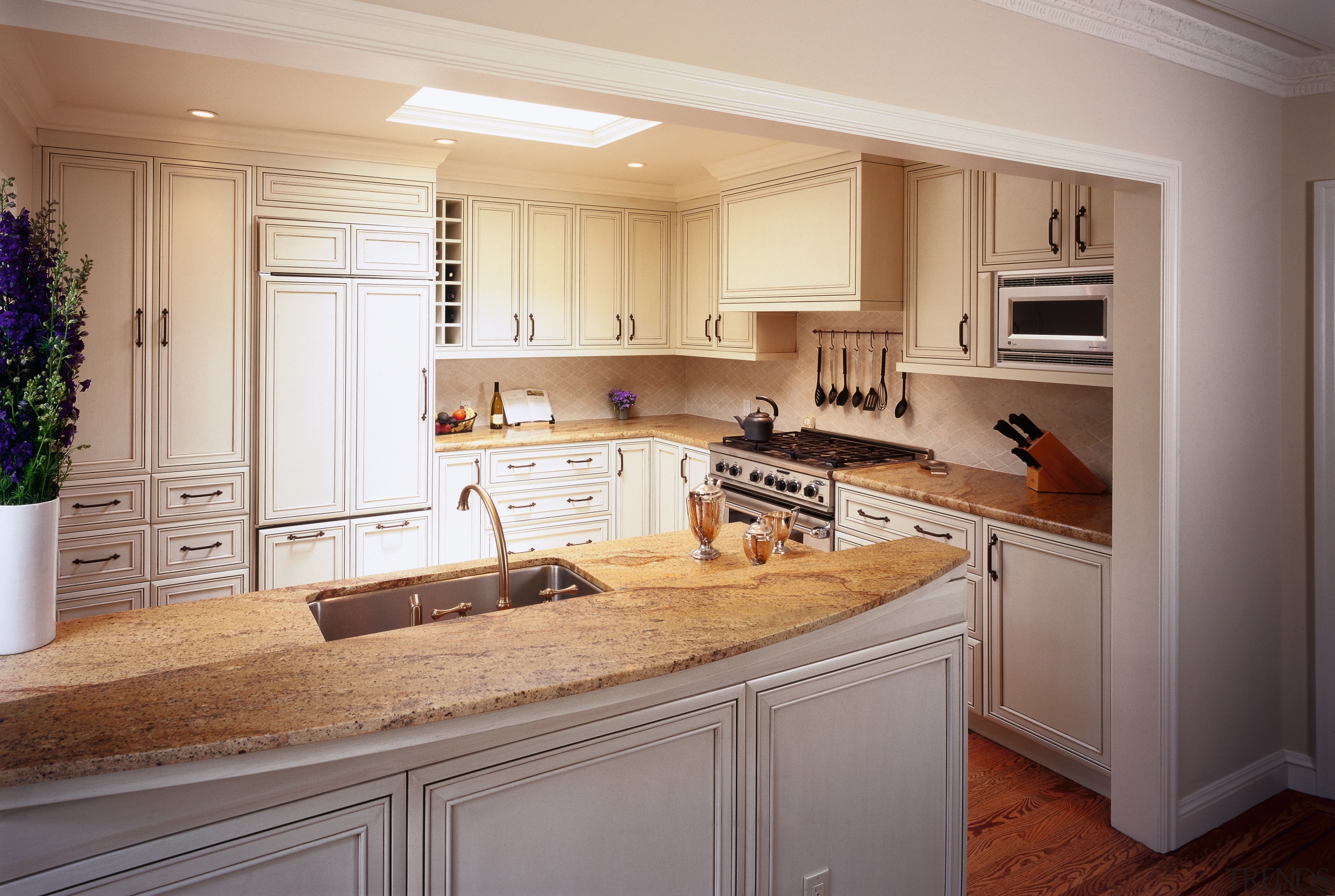 view of the kitchen featuring limestone countertop, timber cabinetry, countertop, cuisine classique, home, interior design, kitchen, room, gray