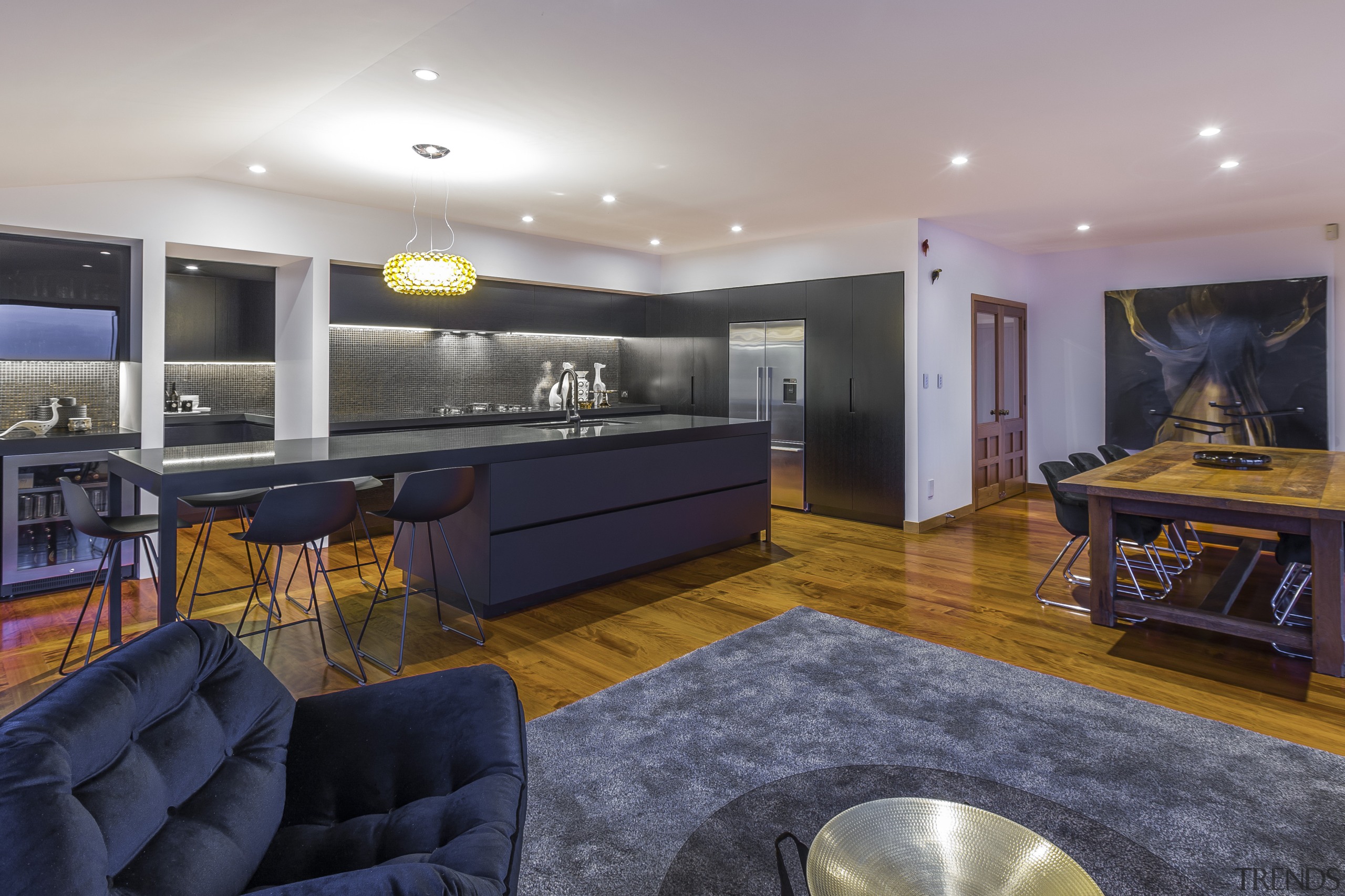 This clean-lined kitchen by designer Morgan Cronin merges apartment, interior design, living room, real estate, room, gray