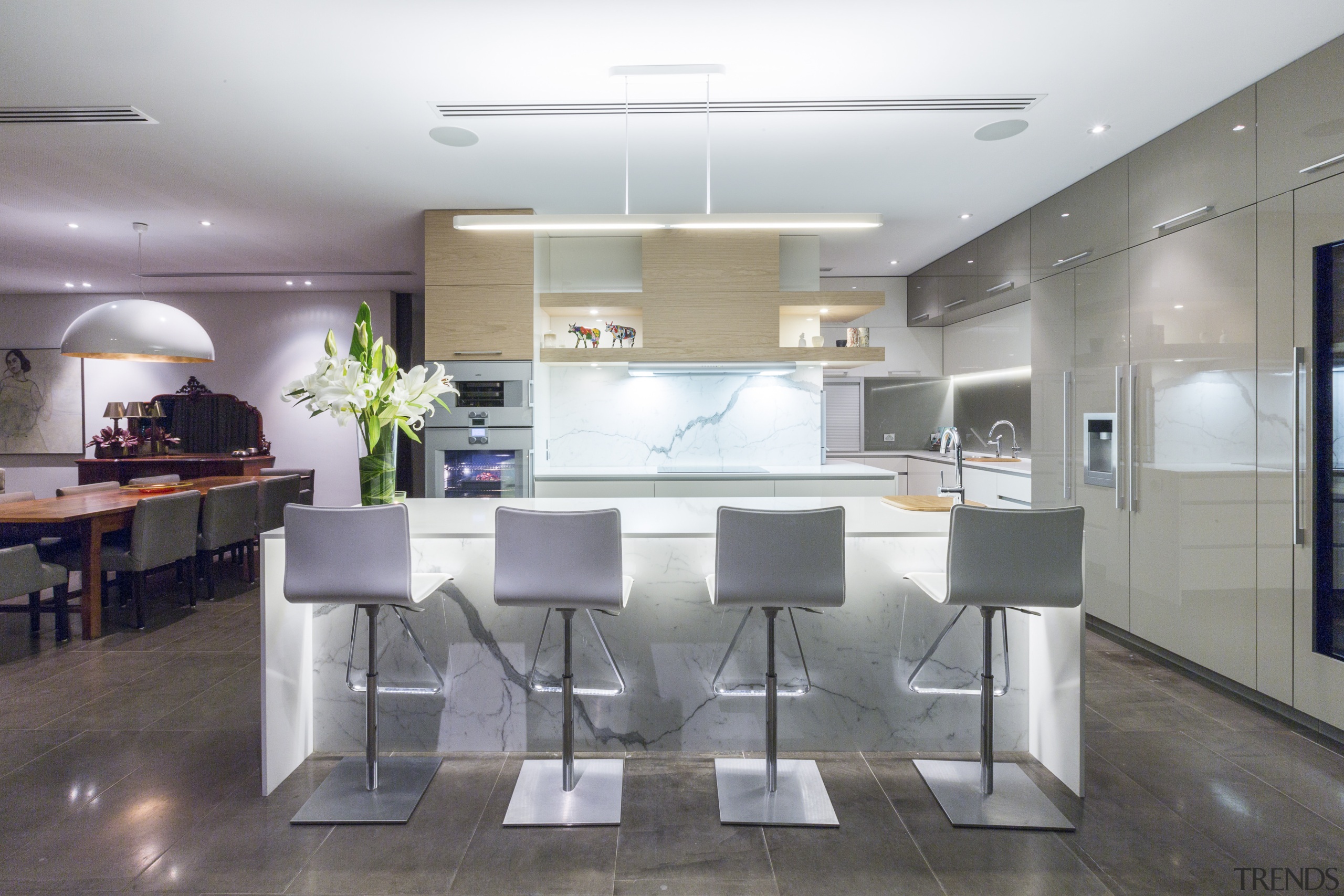 This contemporary kitchen in a renovated 1970s house ceiling, countertop, interior design, kitchen, real estate, table, gray, white