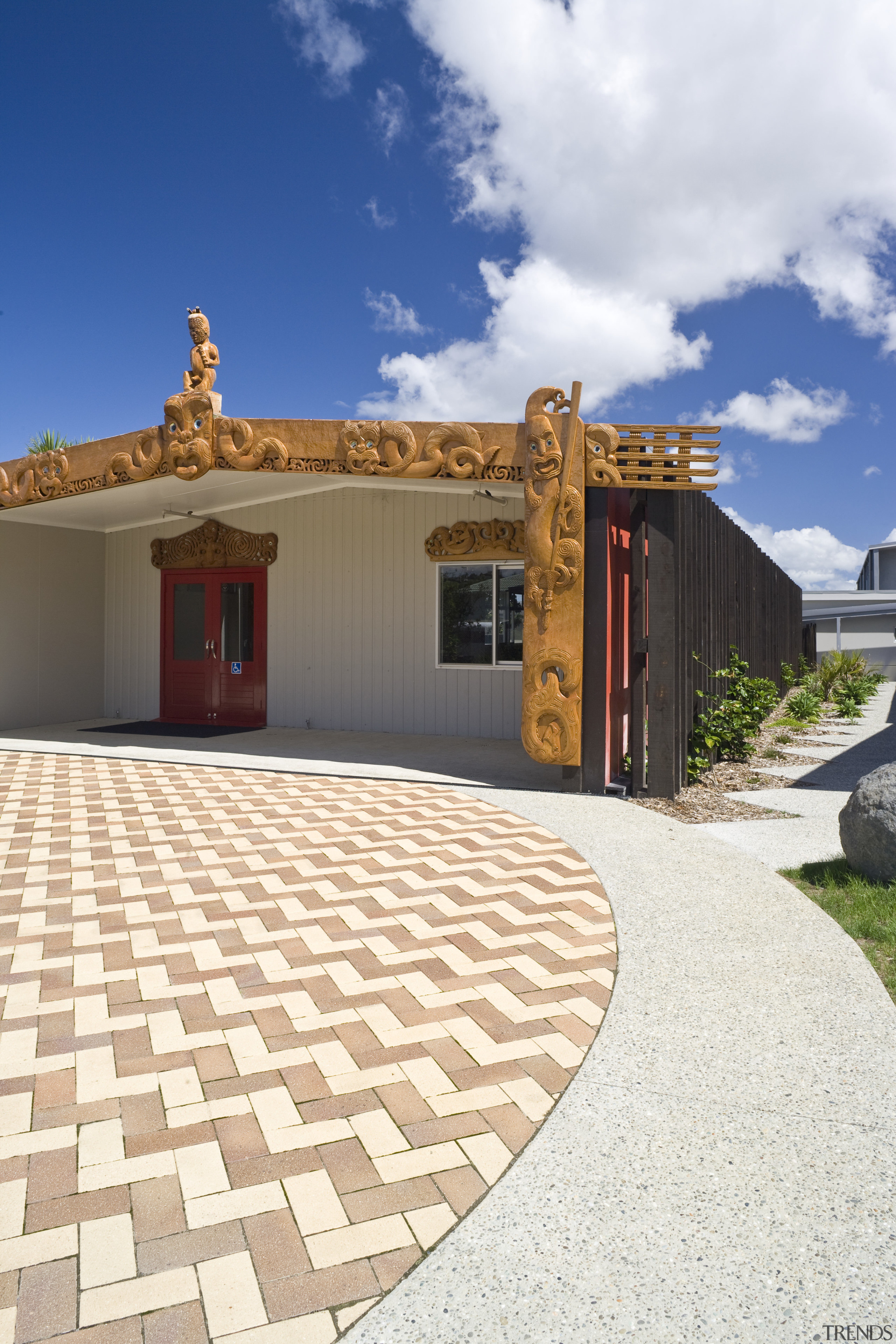 Image of Te Whanau o tupuranga school which architecture, estate, facade, home, house, outdoor structure, property, real estate, roof, sky, white