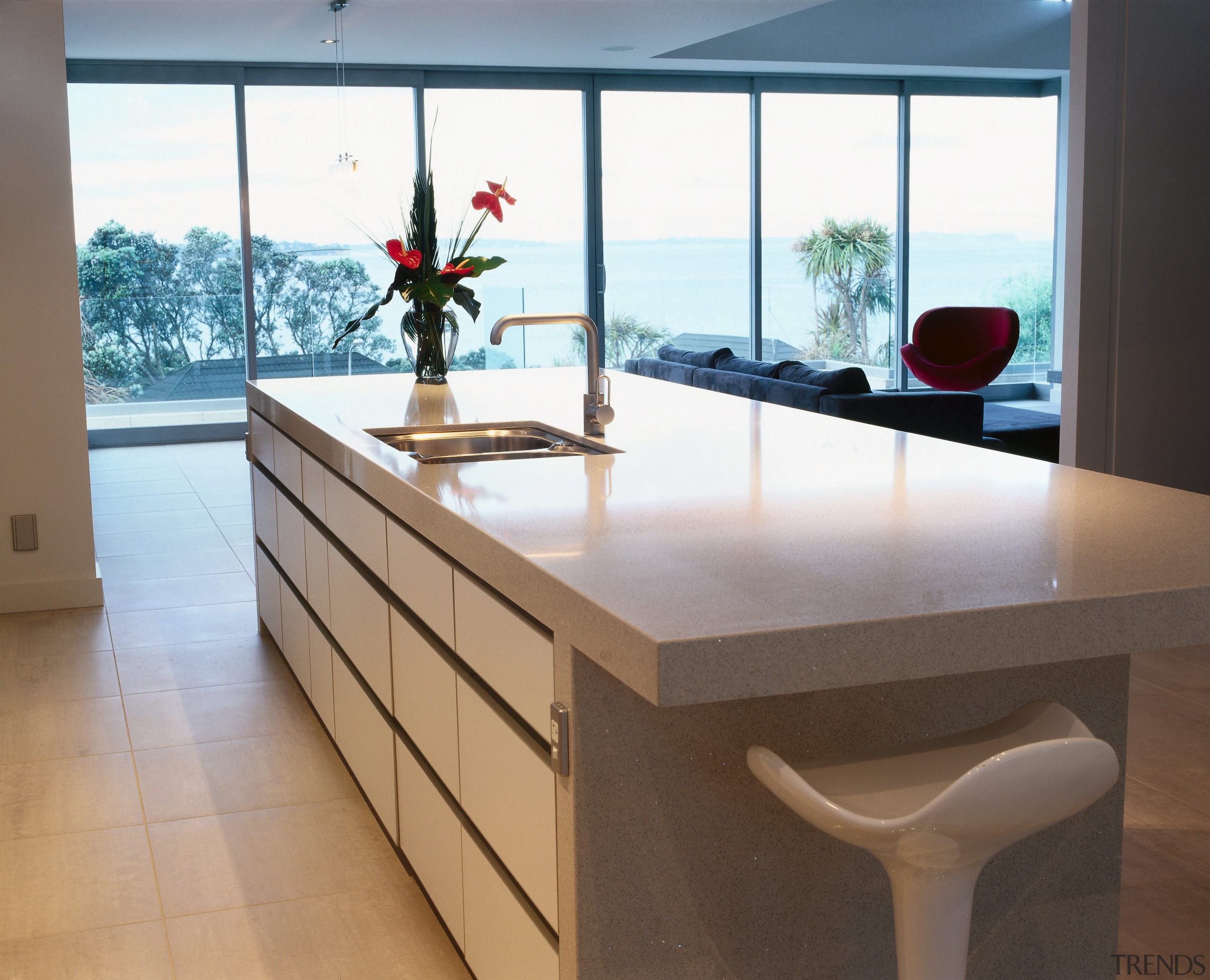 view of the kitchen area showing the granite countertop, floor, furniture, interior design, kitchen, product design, table, white