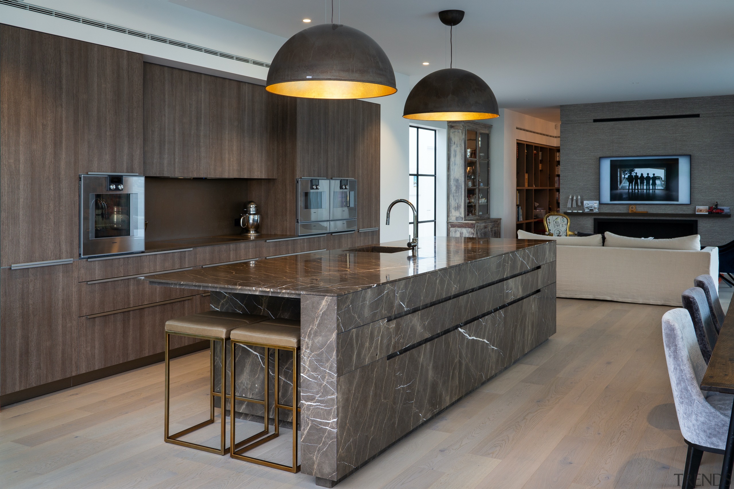 The timber veneer perimeter cabinetry avoids detracting from 