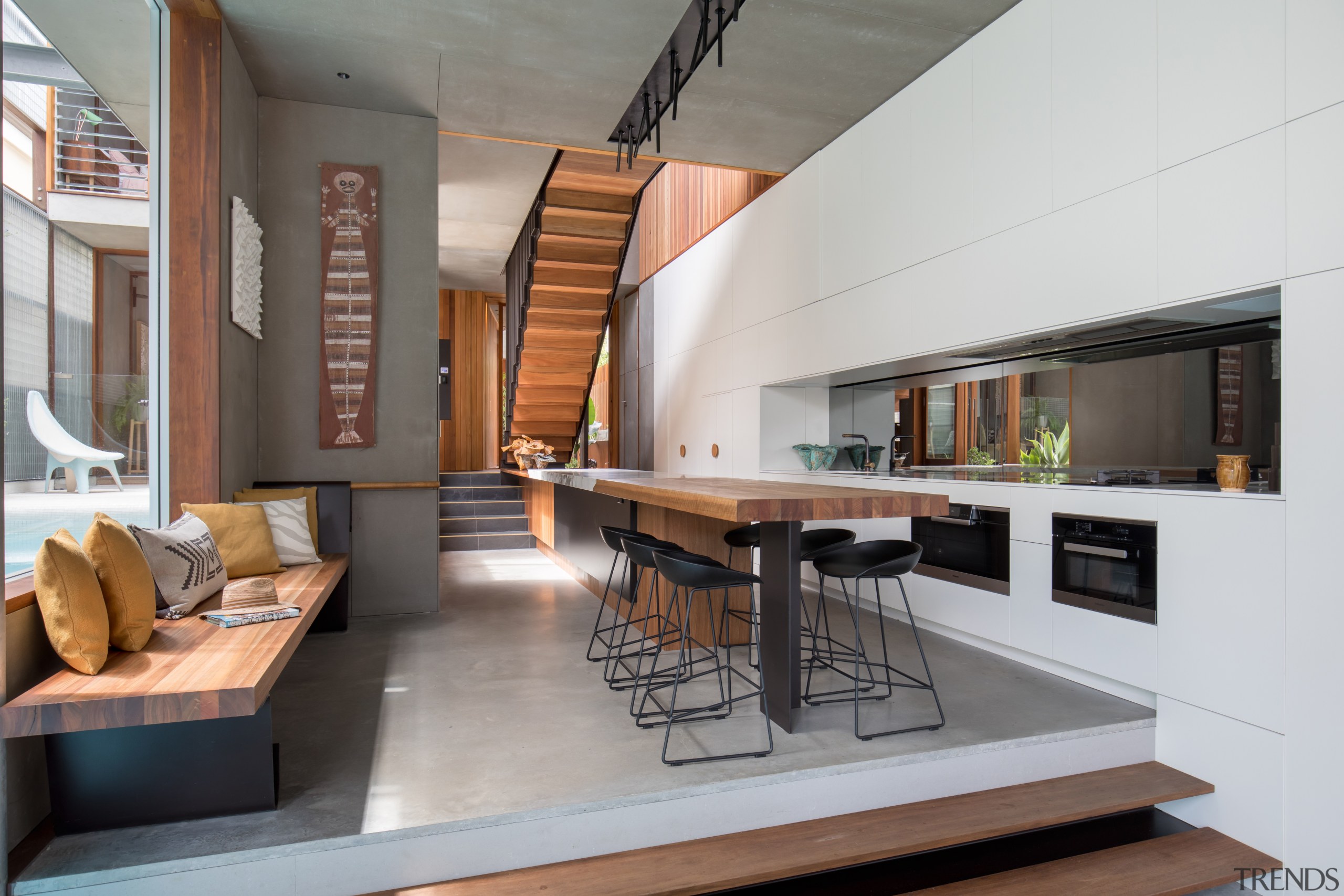 Timber steps provide a subtle delineation between the architecture, house, interior design, living room, gray