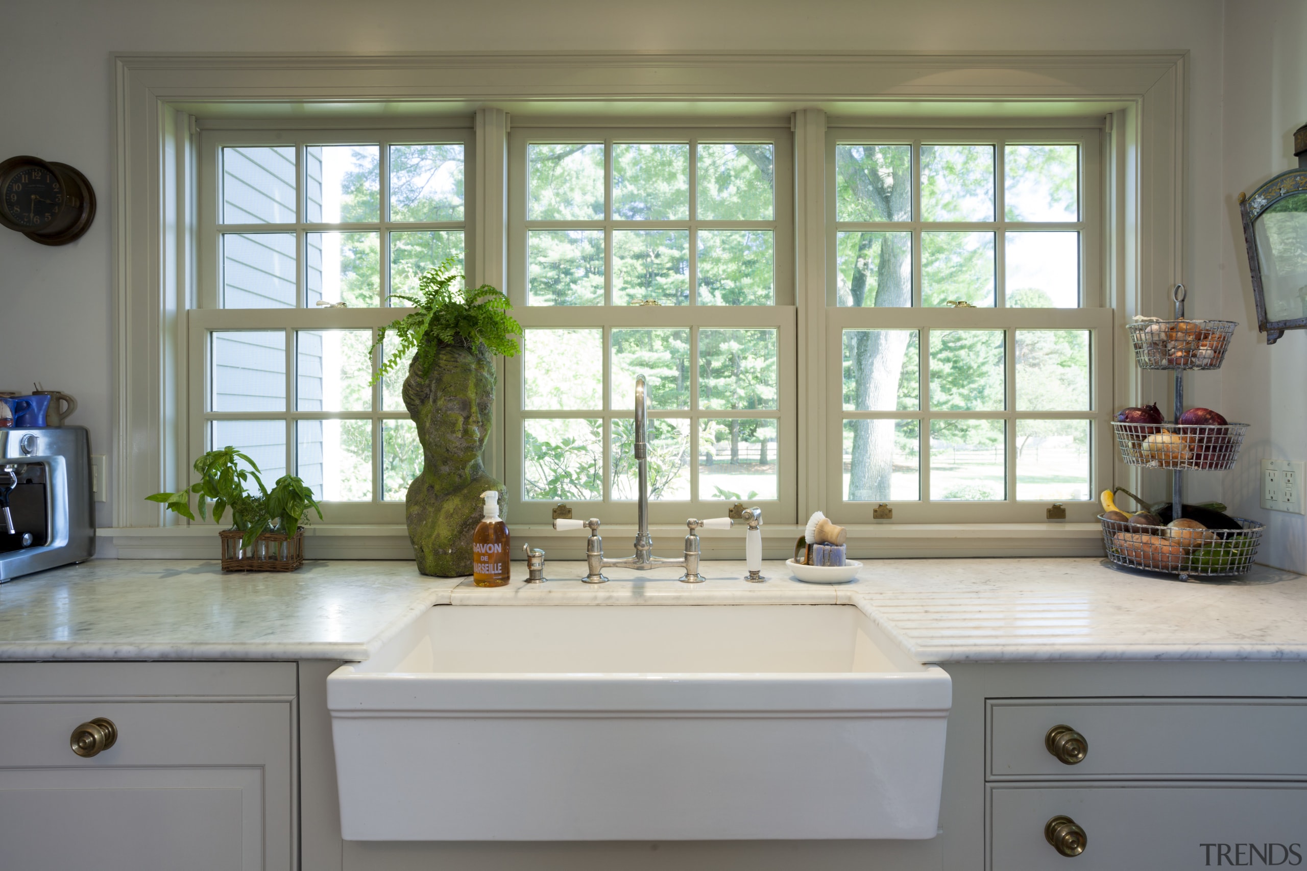 This kitchen blends with its surroundings through architectural cabinetry, countertop, daylighting, home, interior design, kitchen, room, sash window, window, window covering, gray