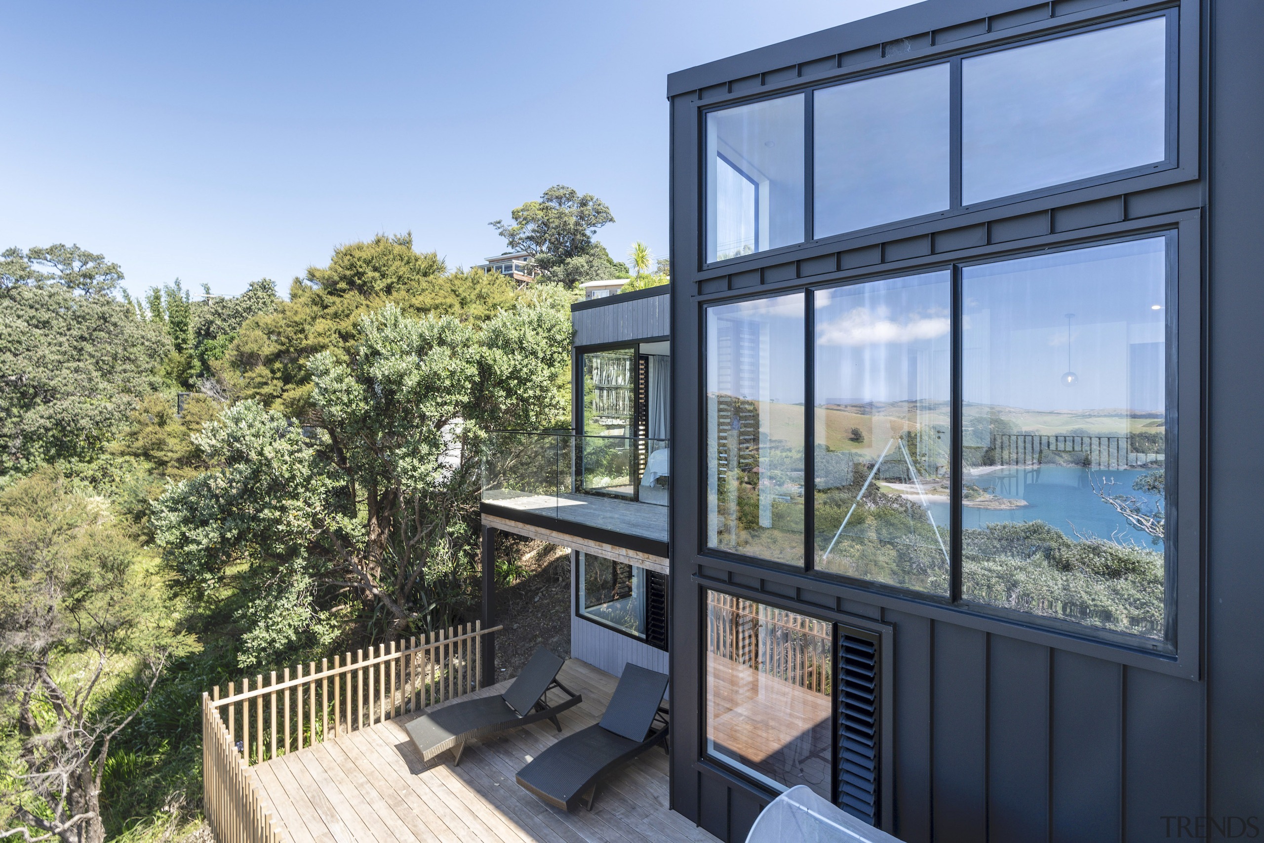 Dramatic black cladding with expansive glazing reflecting the 