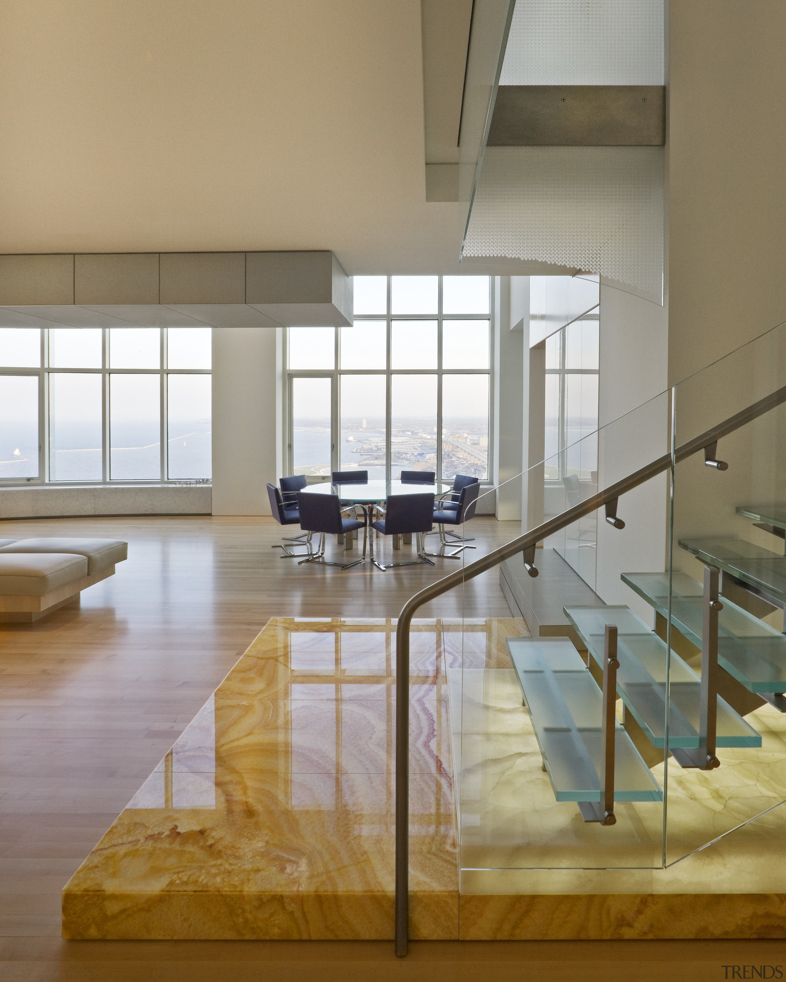 View of penthouse with white walls and a architecture, chair, daylighting, floor, flooring, furniture, glass, handrail, hardwood, interior design, loft, table, window, gray, brown
