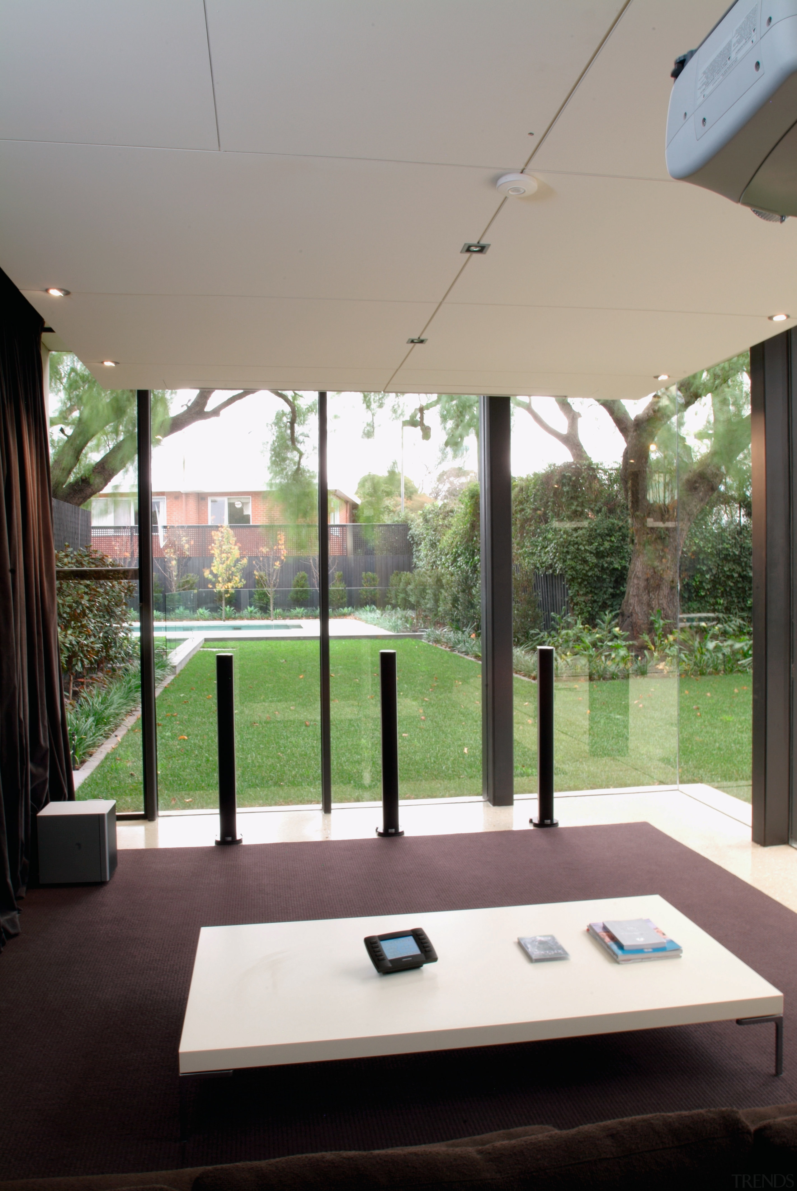 view of the home theatre area also doubling architecture, ceiling, daylighting, furniture, glass, home, house, interior design, table, window, gray