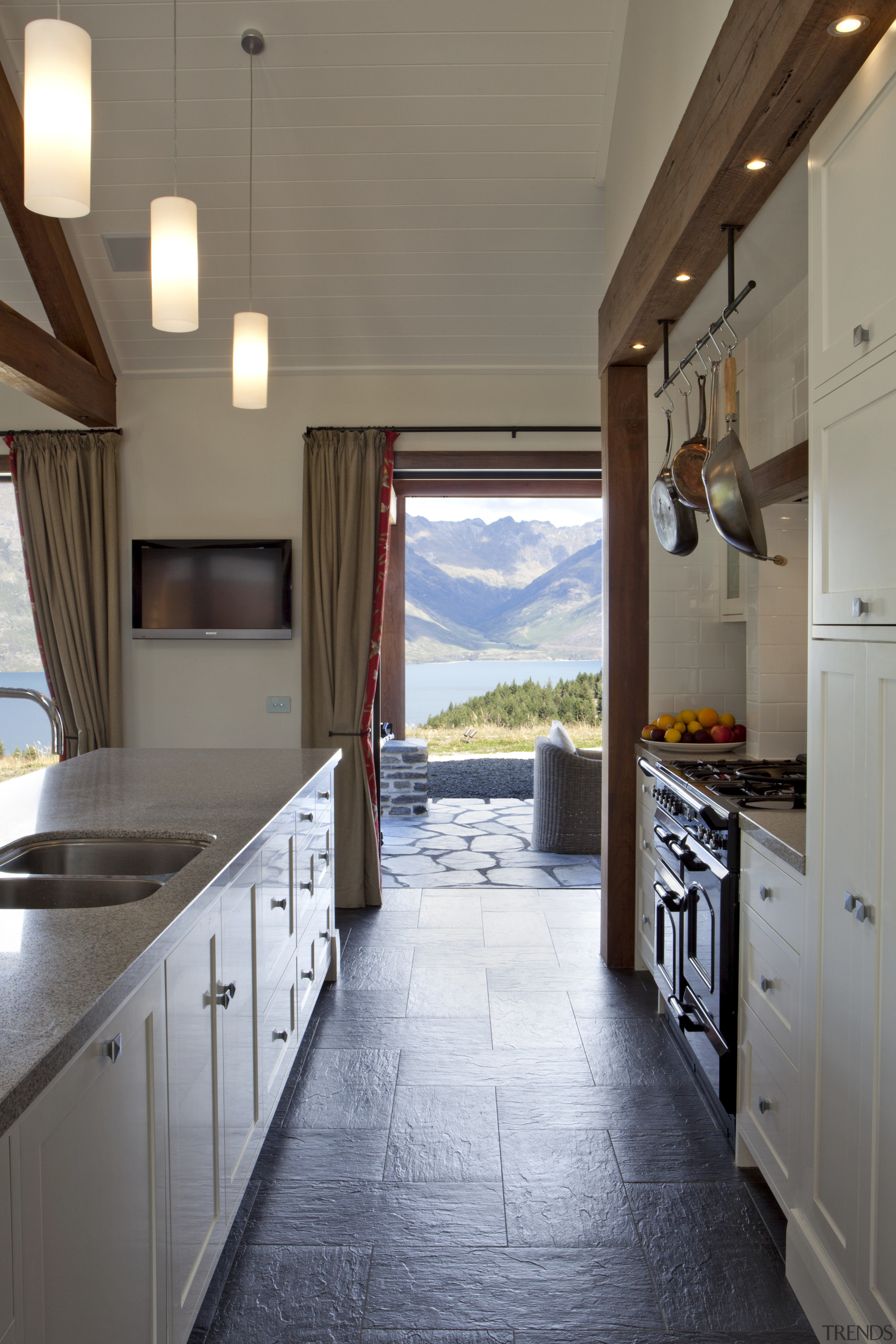 View of kitchen with dark flooring, light toned cabinetry, ceiling, countertop, cuisine classique, floor, flooring, home, house, interior design, kitchen, real estate, room, gray