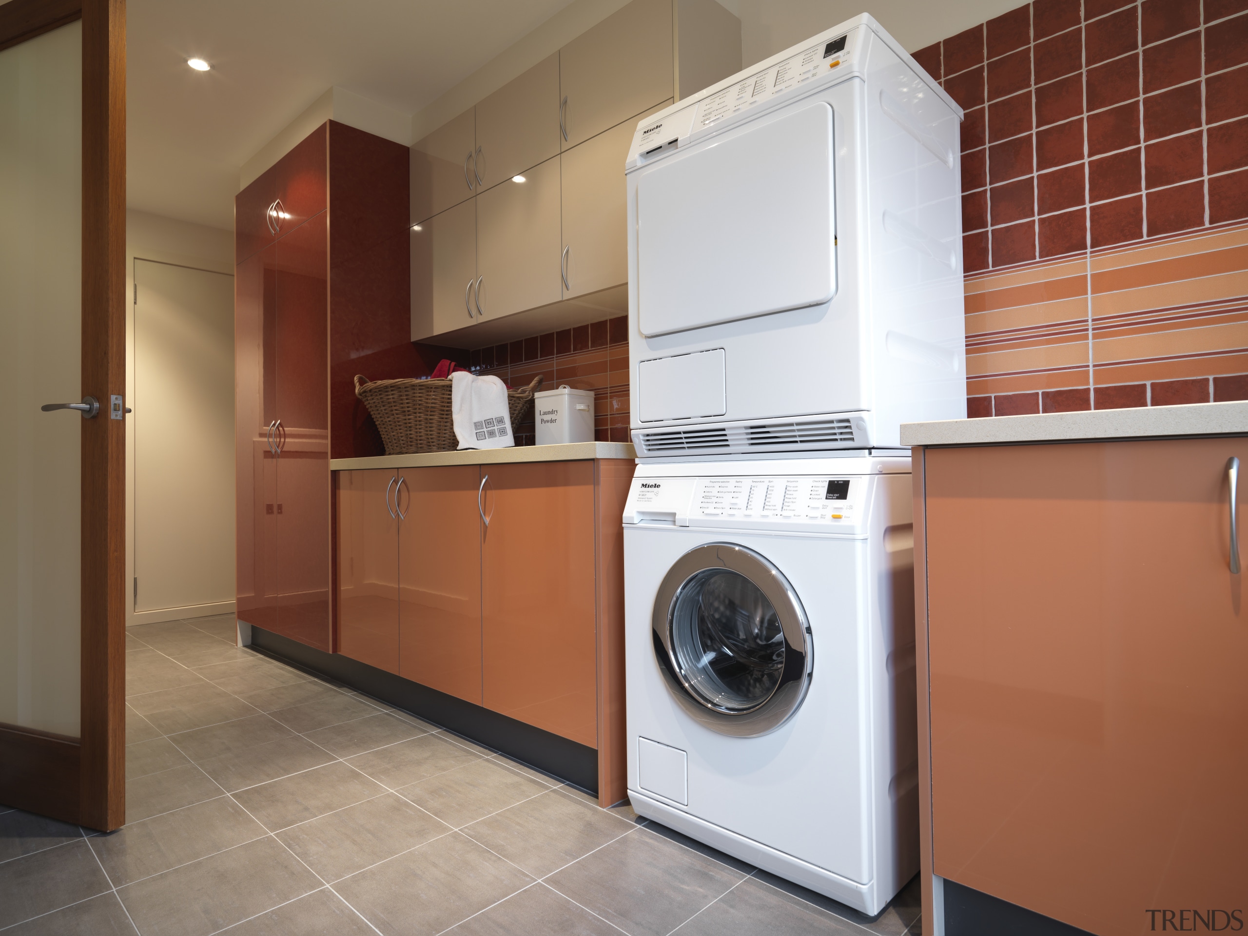 Laundry with grey tiled floor and red cabinets clothes dryer, home appliance, kitchen, laundry room, major appliance, room, washing machine, brown