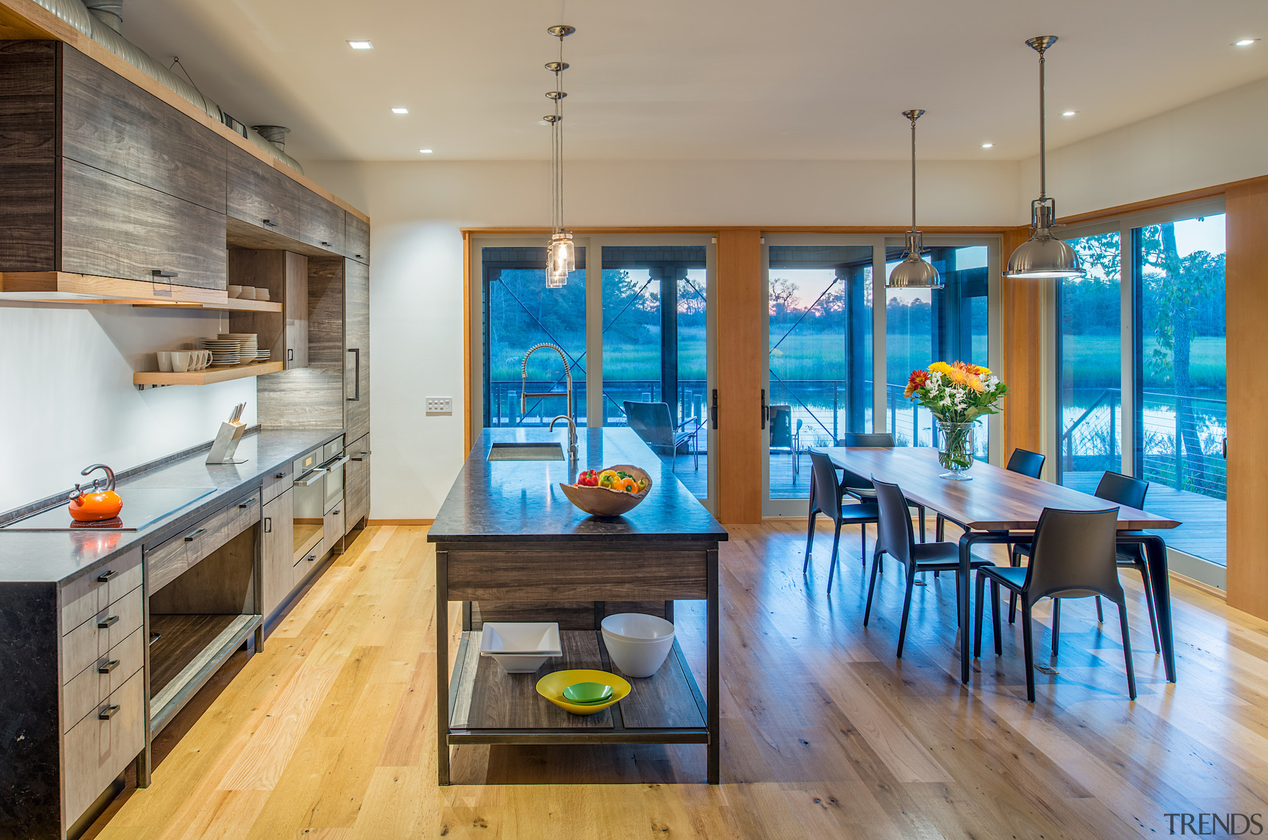 The honed dark stone countertop blends well with 