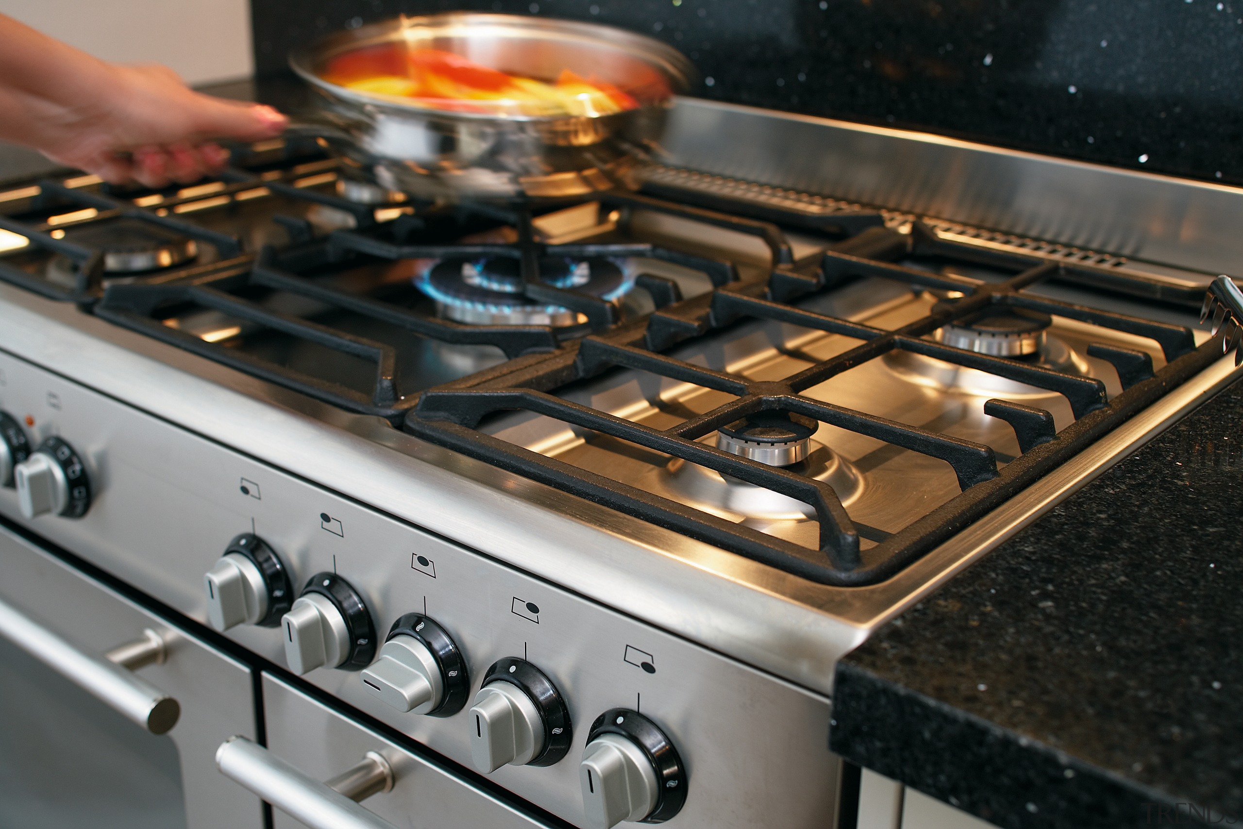 view of this kitchen featuring white granite benchtop, cookware and bakeware, gas stove, kitchen appliance, kitchen stove, black, gray