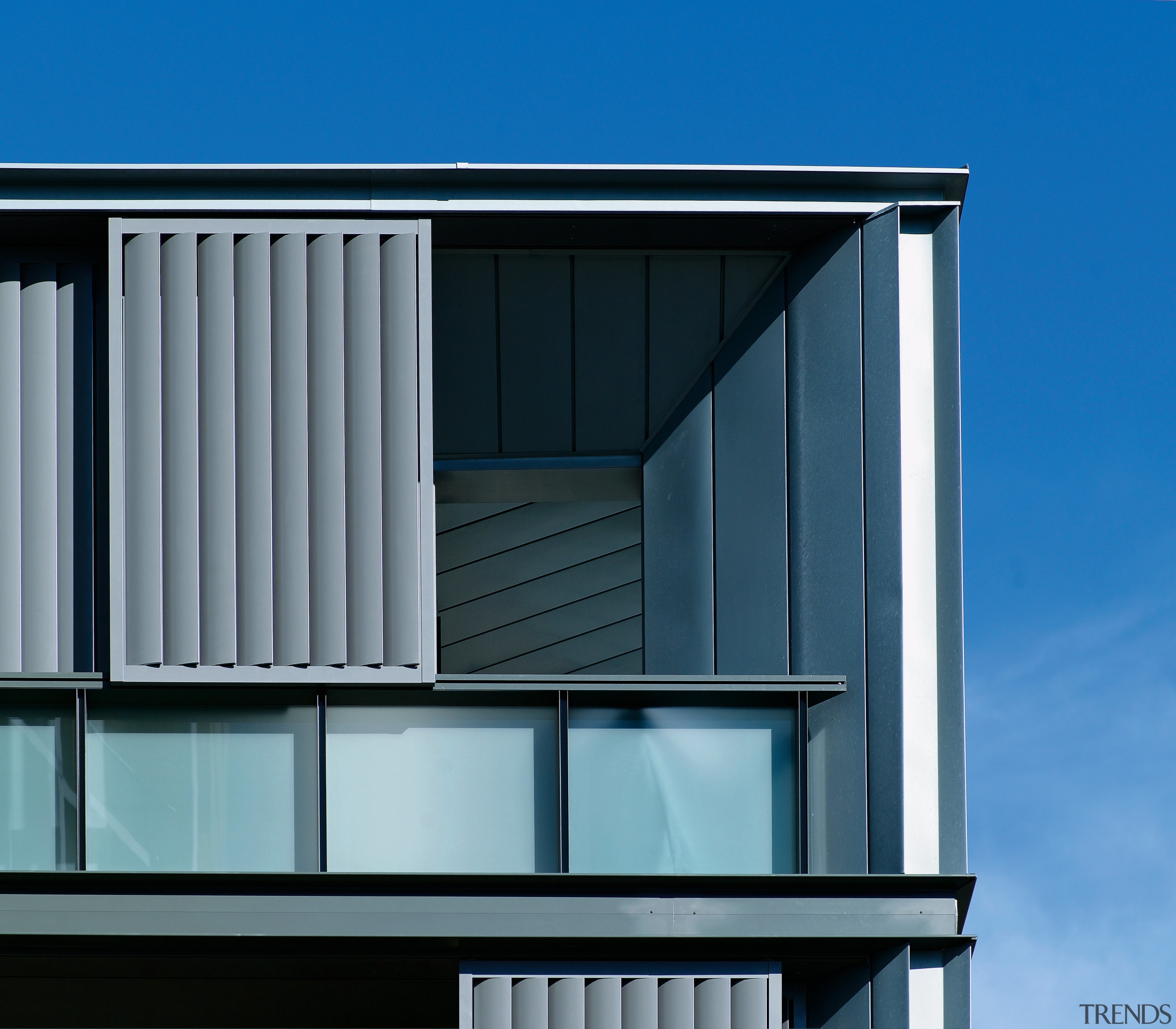 Exterior view of apartment building showing metal titanium architecture, building, commercial building, daylighting, elevation, facade, home, house, line, residential area, roof, siding, sky, window