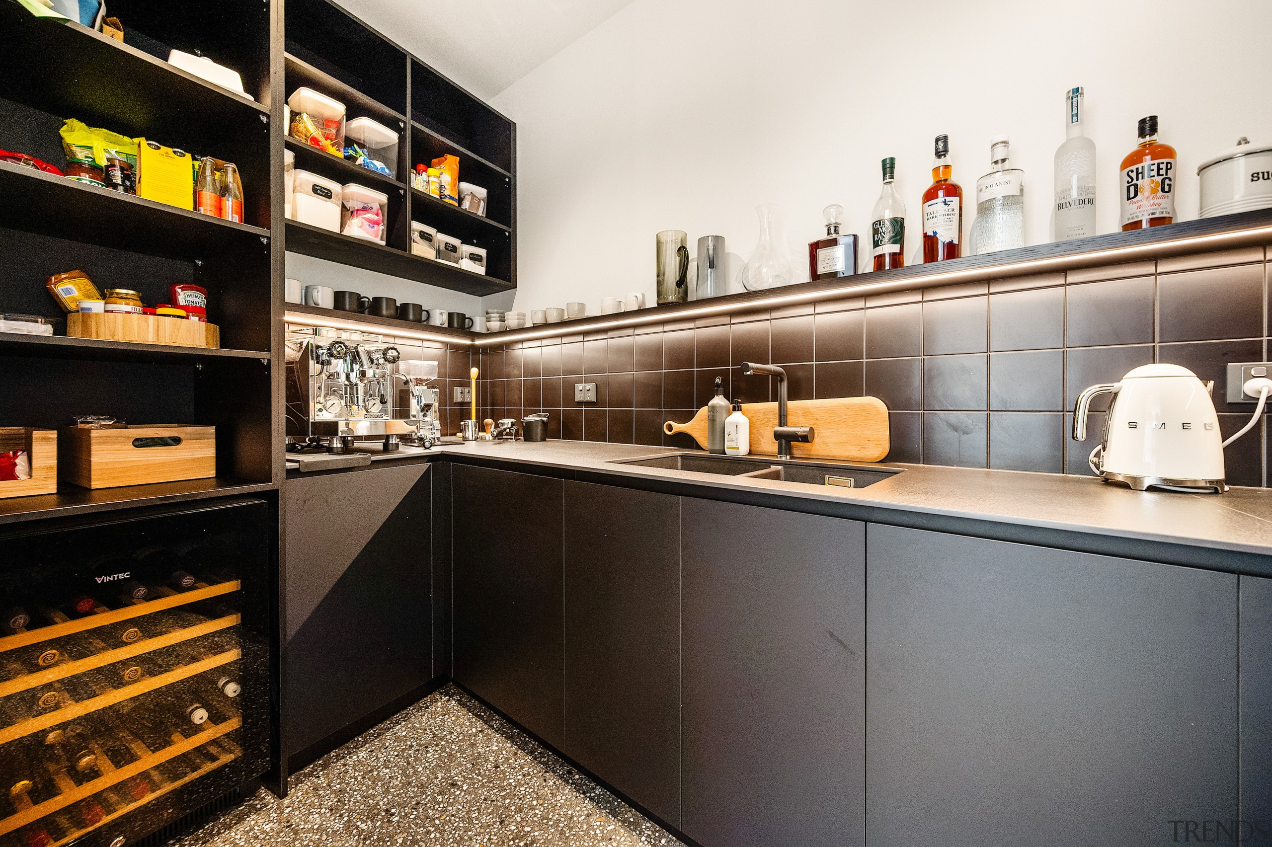 The scullery continues the cabinetry tones of the 