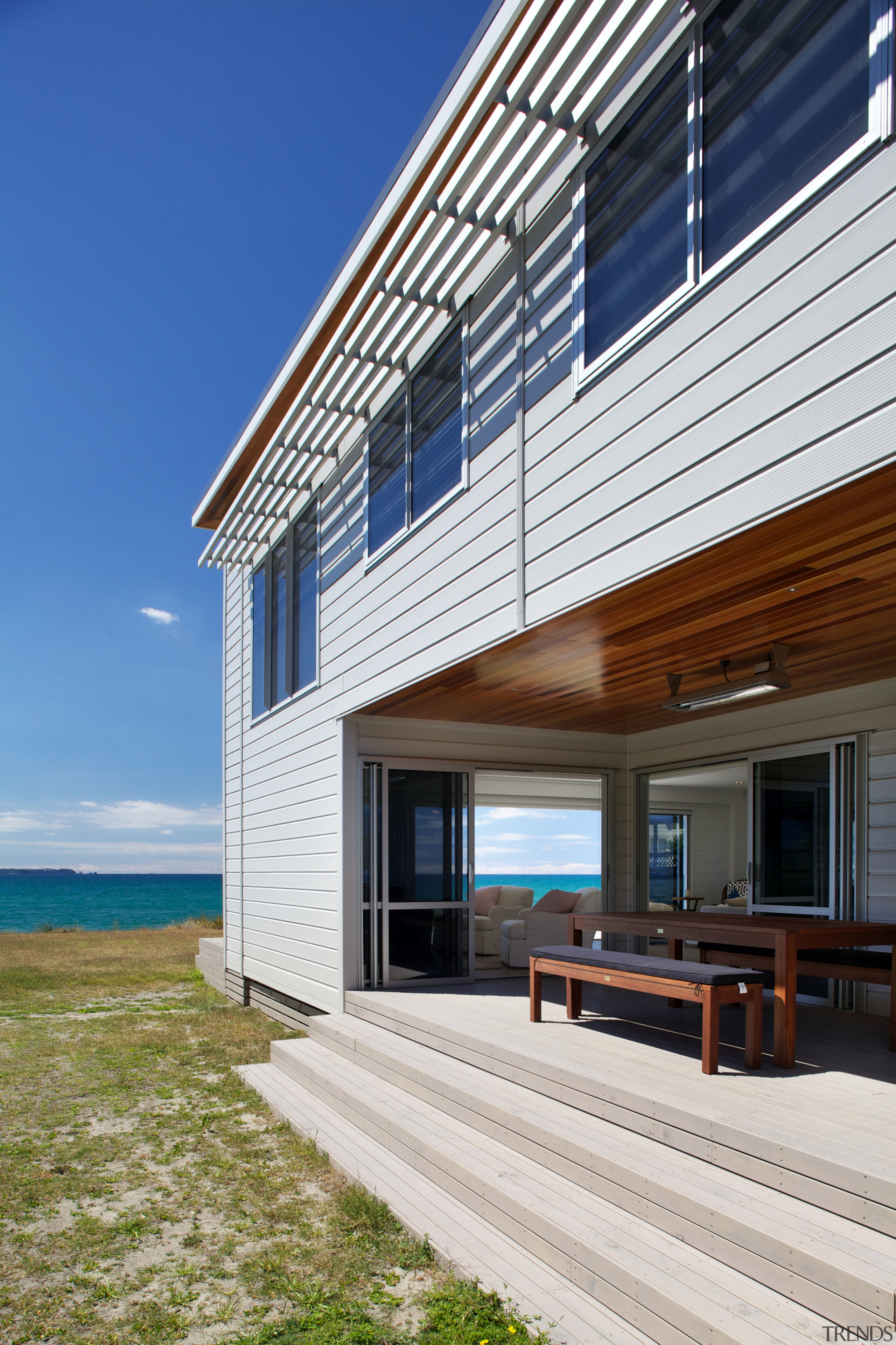 This new Lockwood home takes its cue from architecture, building, corporate headquarters, cottage, daylighting, elevation, estate, facade, home, house, real estate, residential area, siding, sky, window, wood, blue