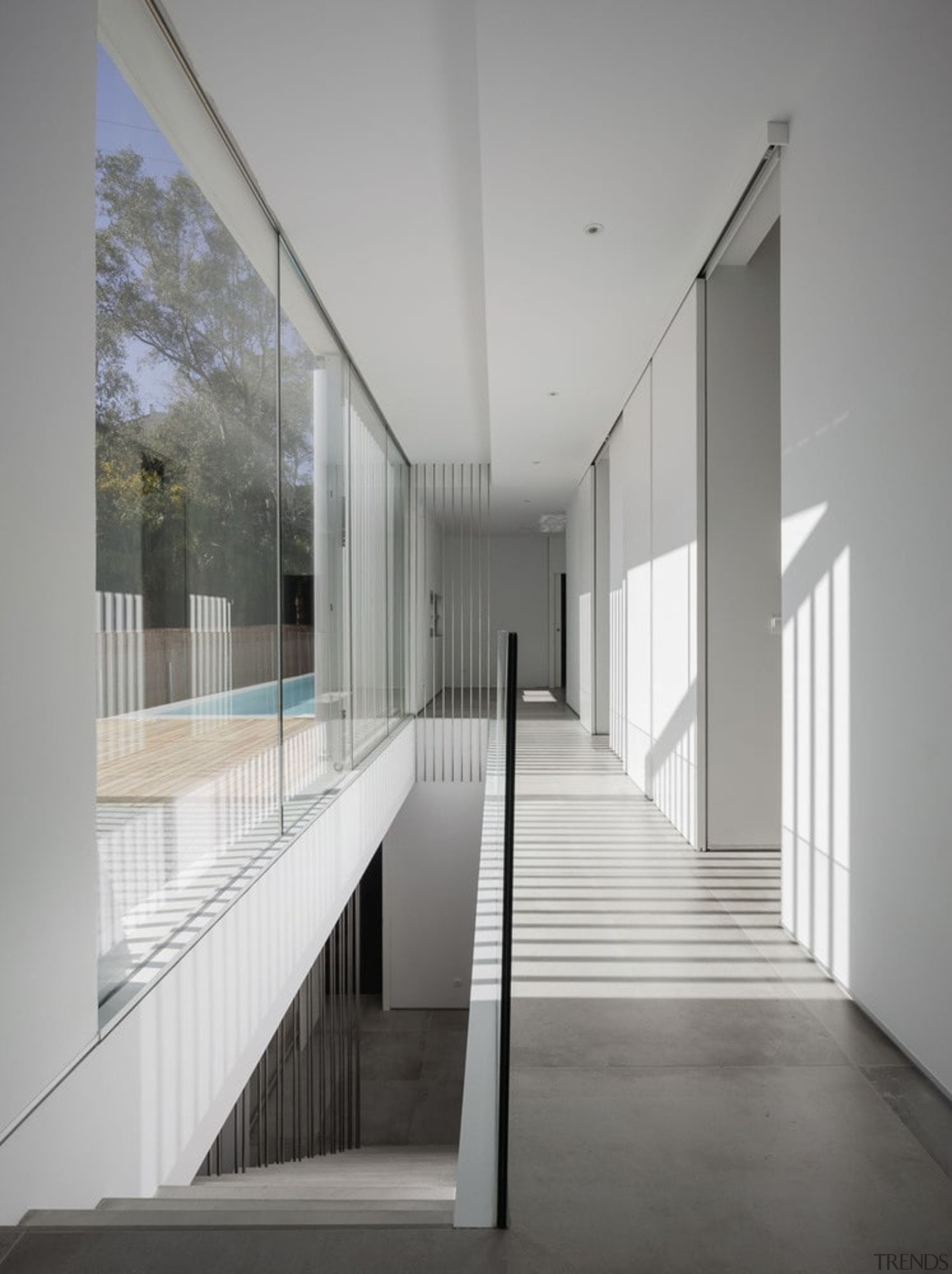 Floor to ceiling windows run the length of architecture, ceiling, daylighting, glass, handrail, house, interior design, gray