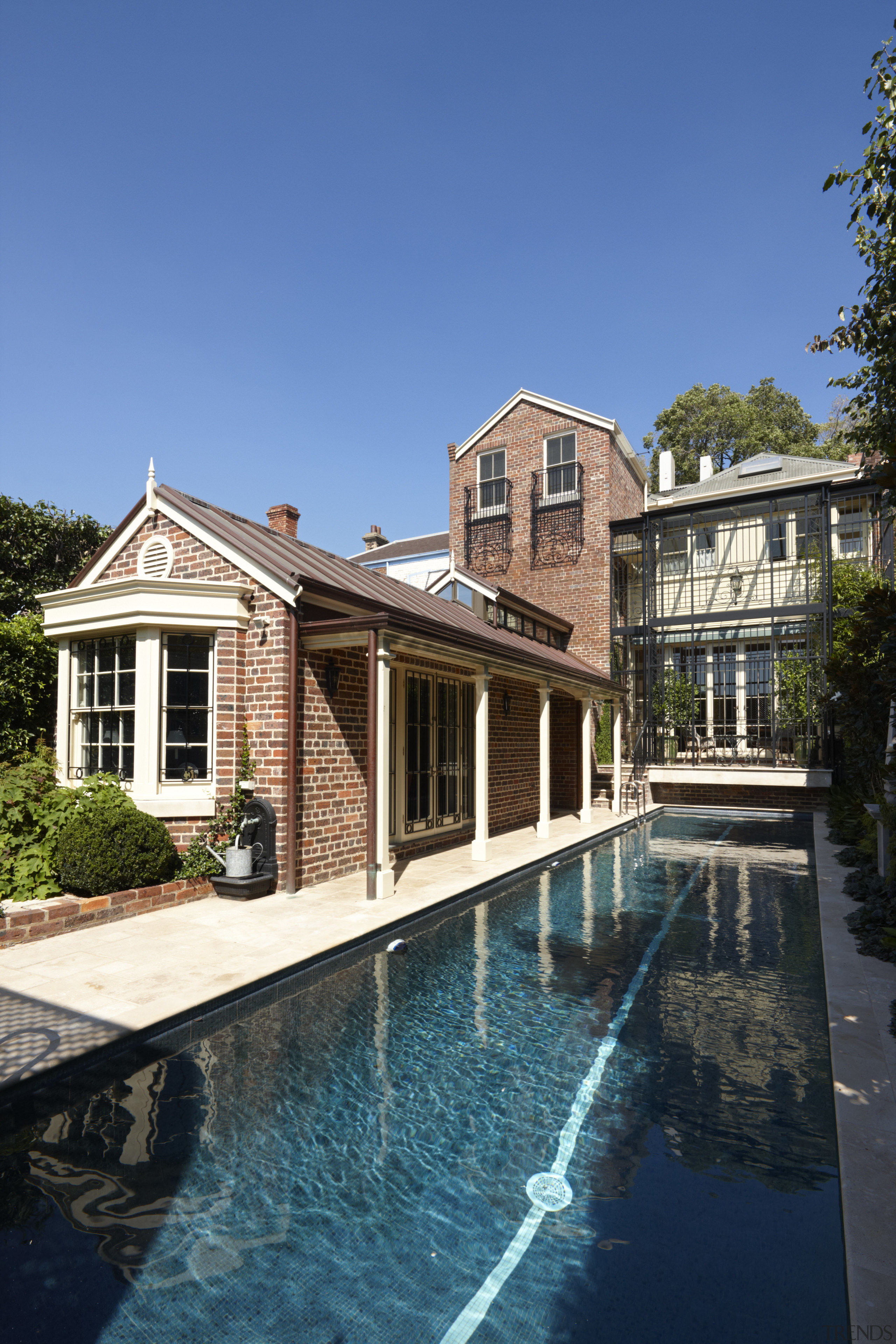 View of outdoor pool area - View of building, cottage, estate, facade, home, house, mansion, property, real estate, reflection, residential area, siding, sky, suburb, swimming pool, villa, water, waterway, window, teal