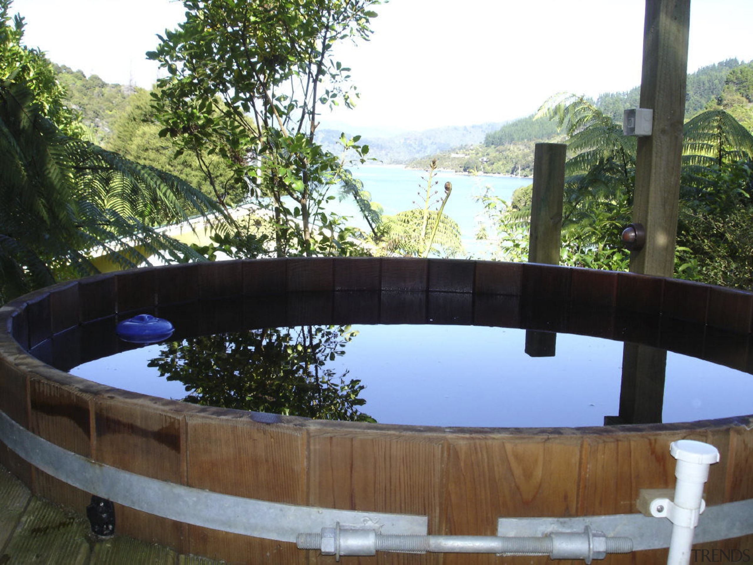 Close-up view of the traditional tub - Close-up backyard, outdoor structure, plant, property, reflection, swimming pool, tree, water, wood