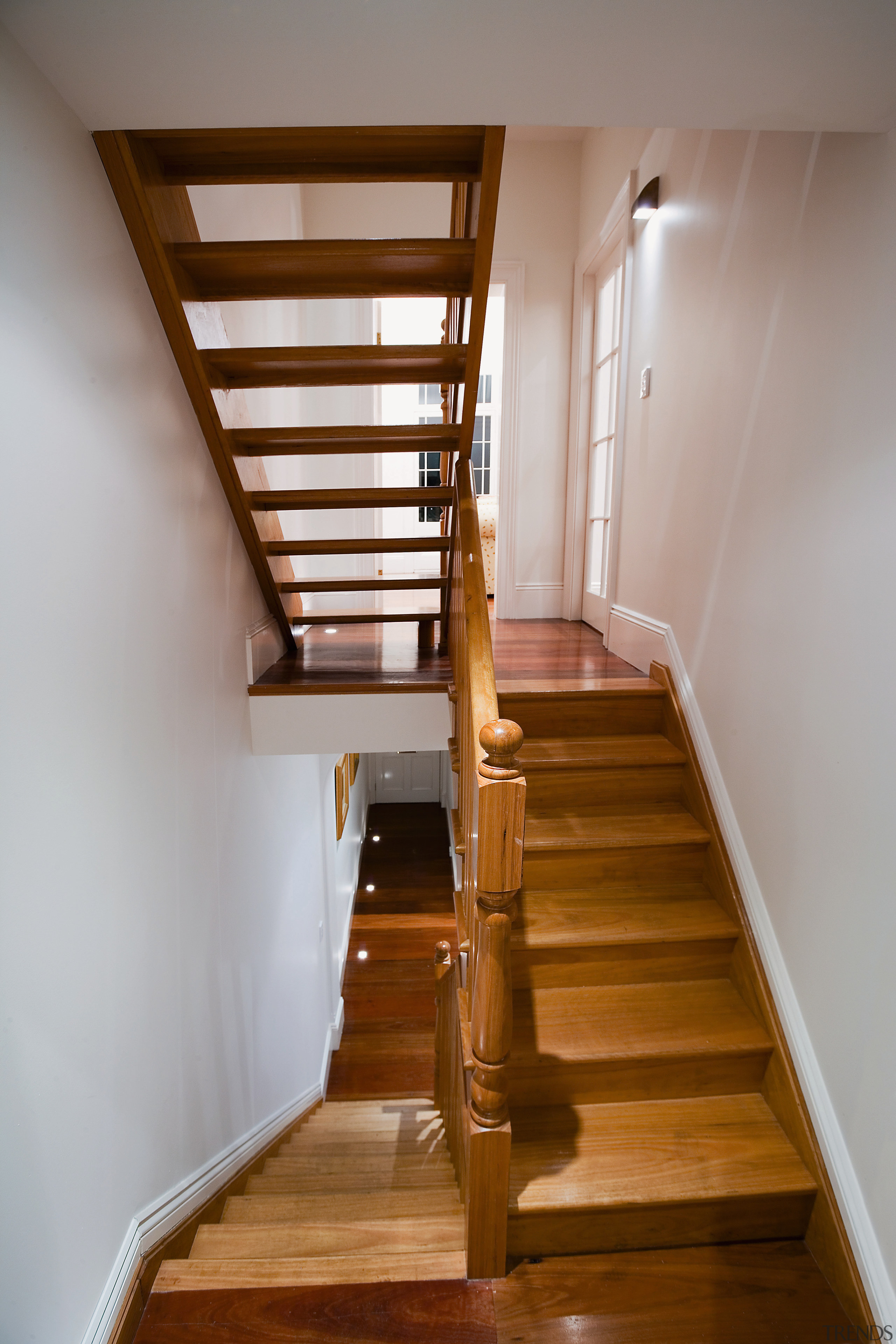 A view of a wooden staircase. - A daylighting, handrail, hardwood, home, house, interior design, stairs, wood, gray, brown