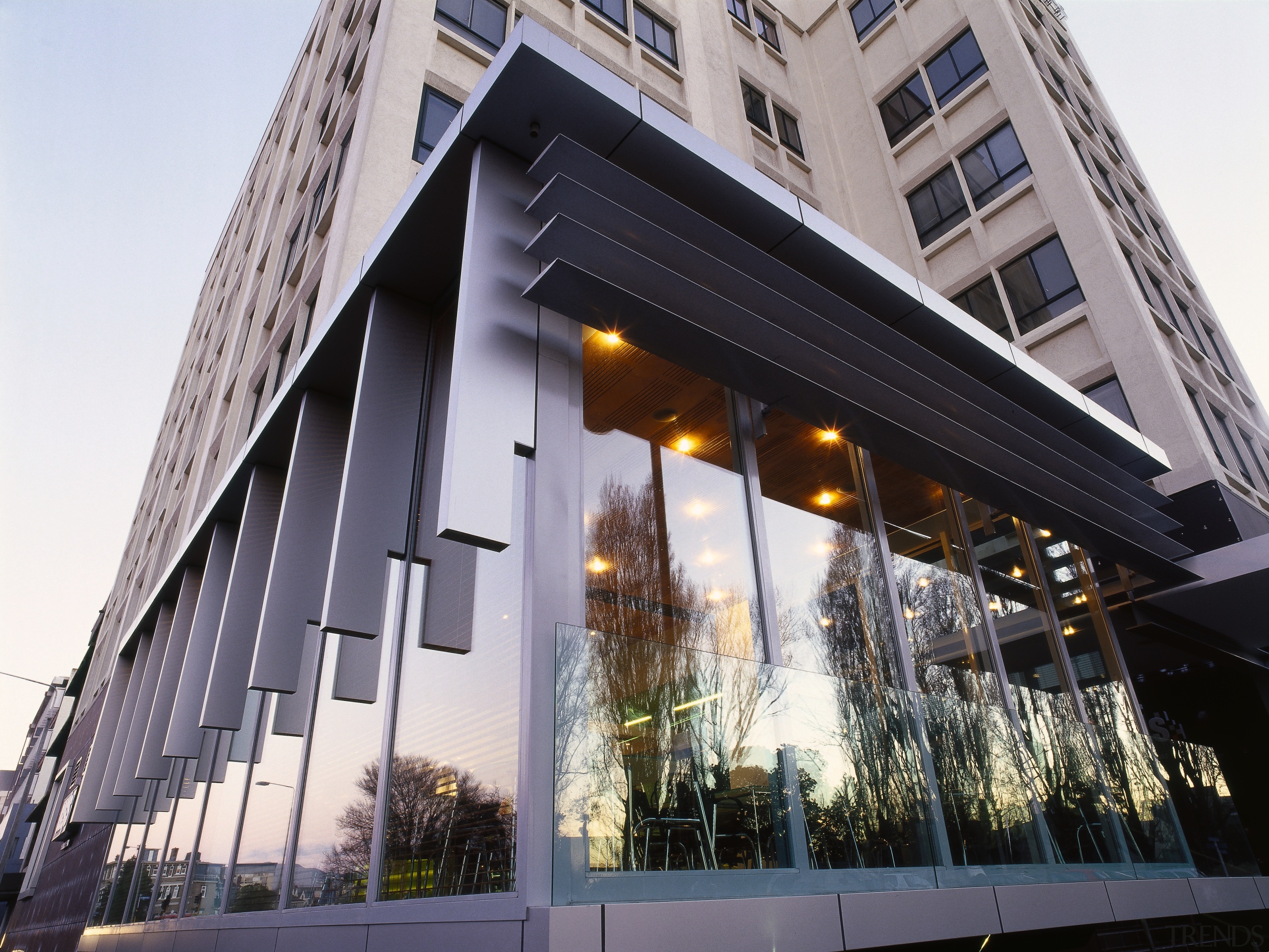 Close-up exterior view of the Poplars apartments, taken apartment, architecture, building, commercial building, condominium, corporate headquarters, facade, headquarters, house, mixed use, property, real estate, window, white, black, gray