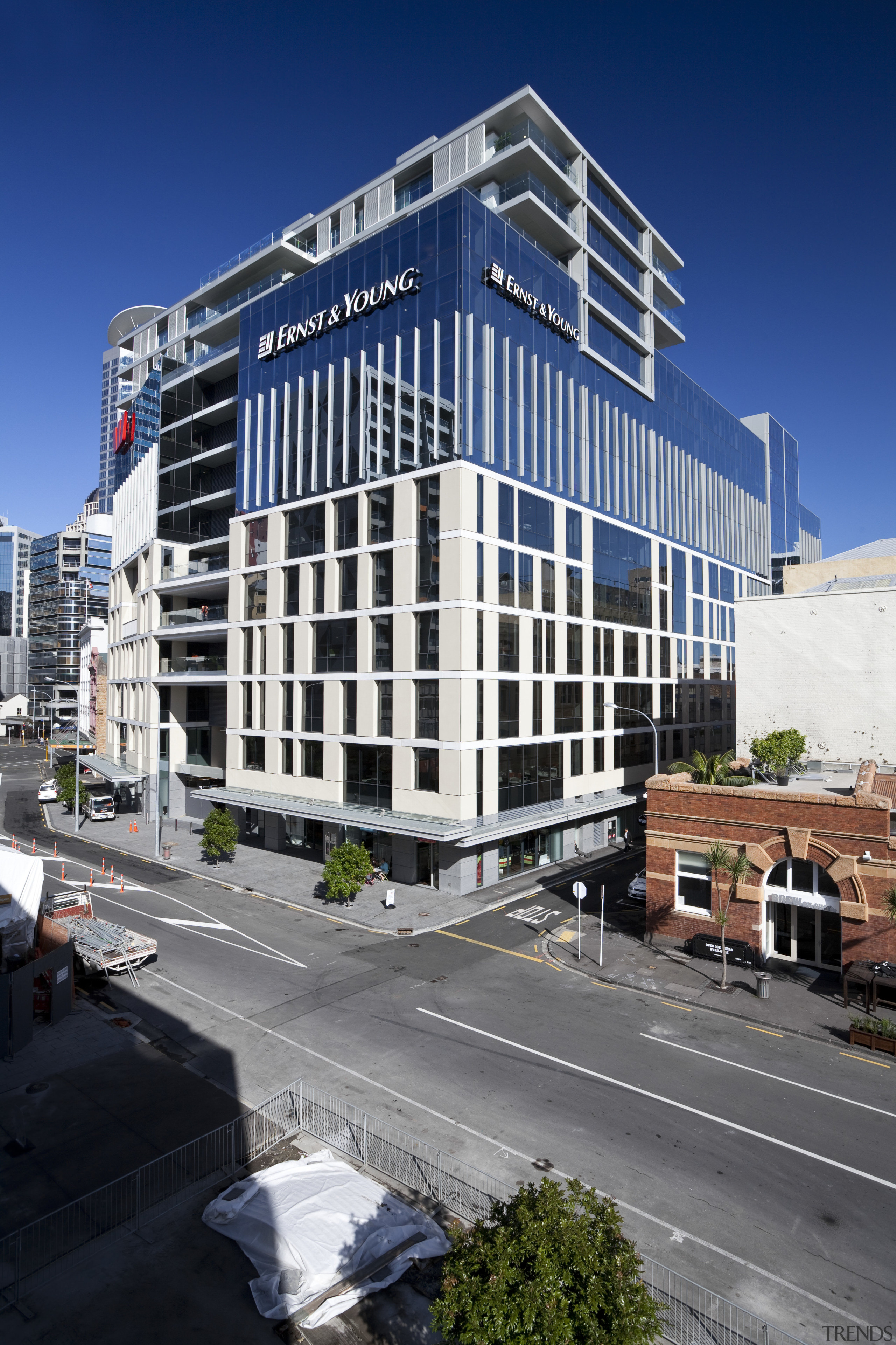 Exterior view of a building at the Britomart apartment, architecture, building, city, commercial building, condominium, corporate headquarters, daytime, downtown, facade, headquarters, metropolis, metropolitan area, mixed use, neighbourhood, real estate, residential area, sky, skyscraper, tower block, urban area, blue