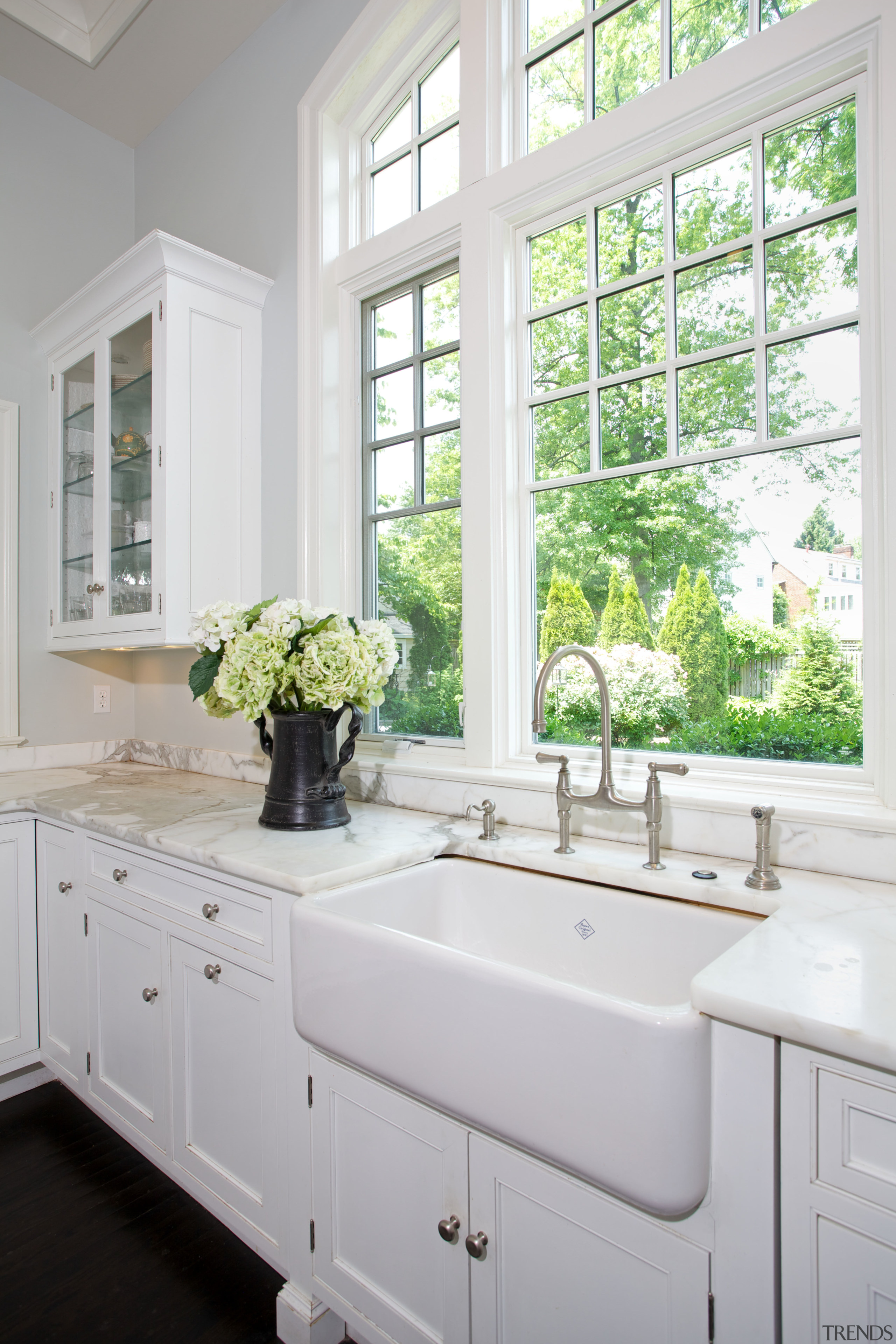 Transitional paneling and metal pulls are matched with bathroom, bathroom accessory, bathroom cabinet, cabinetry, countertop, home, interior design, kitchen, room, sink, window, gray, white