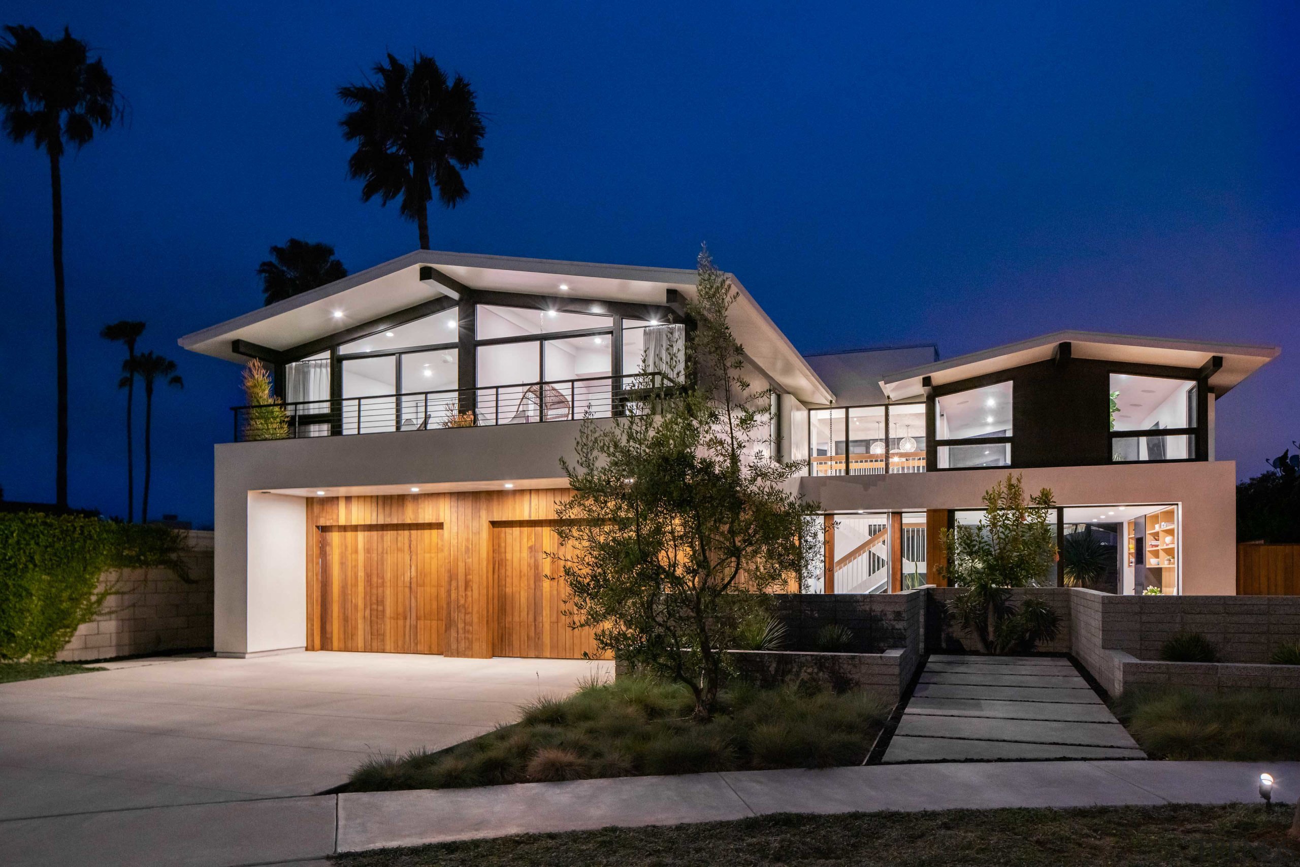 The house glowing under a Californian night sky. 