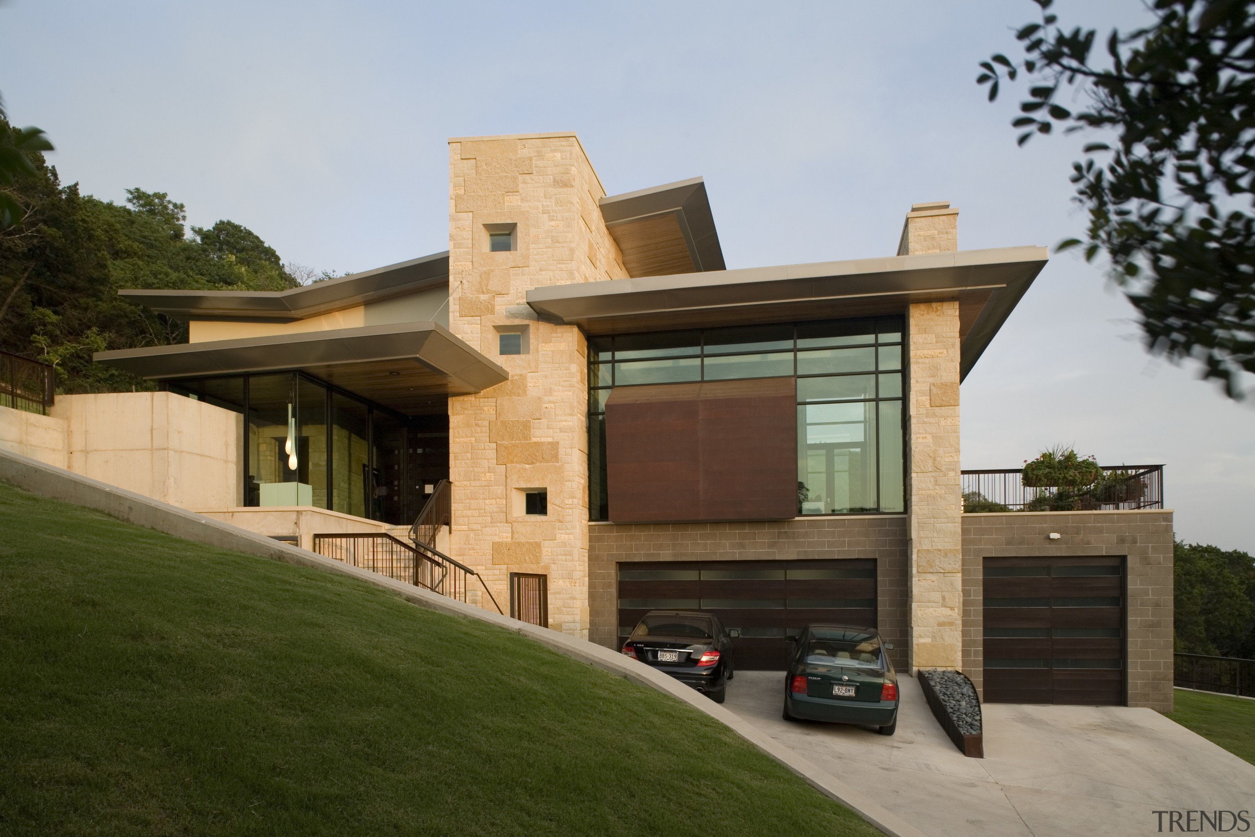 Contemporary home features unique stone design - Contemporary architecture, building, elevation, estate, facade, home, house, property, real estate, residential area, roof, siding, brown, gray