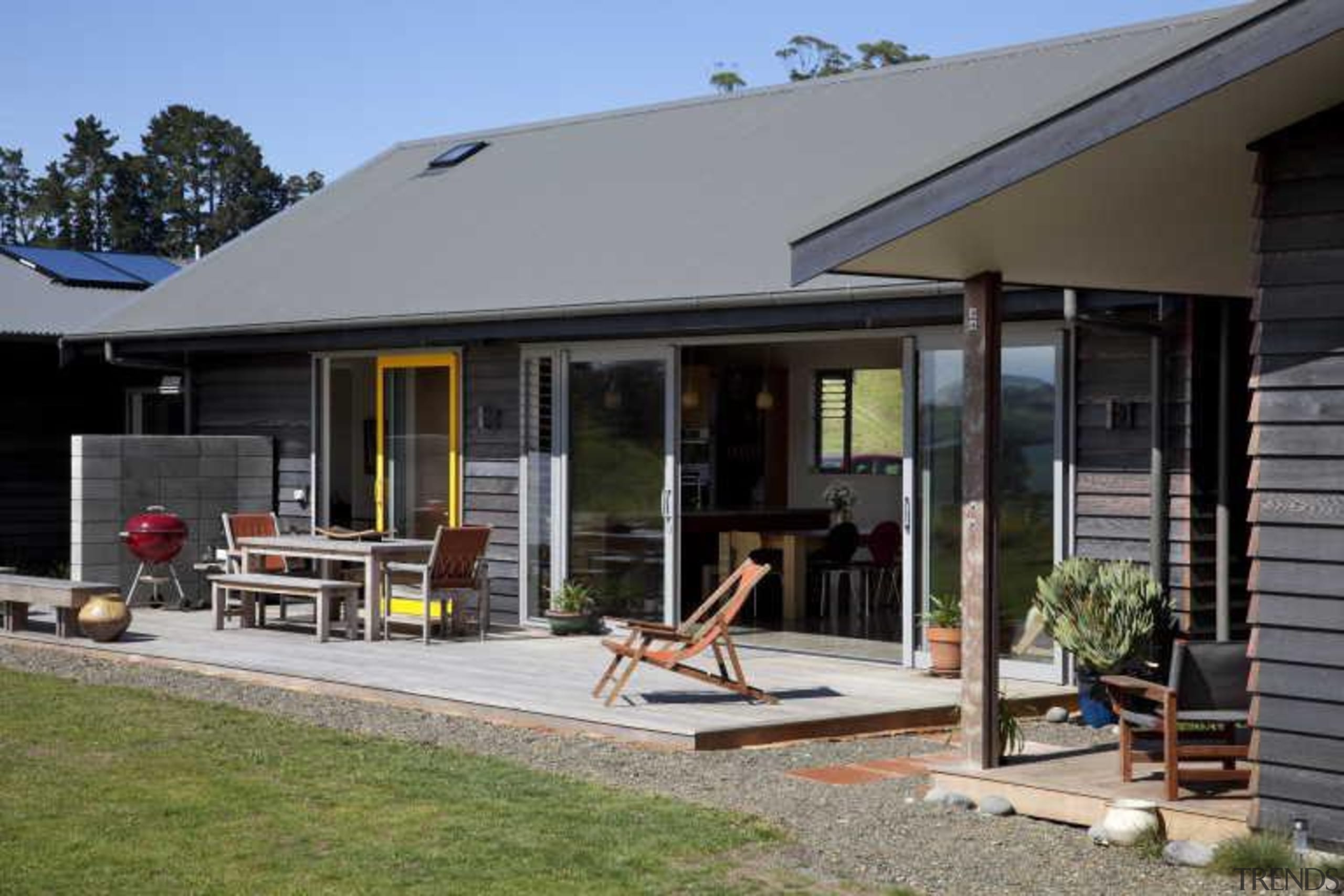 View of exterior with patio and yellow window cottage, home, house, outdoor structure, porch, property, real estate, siding, window, gray, black