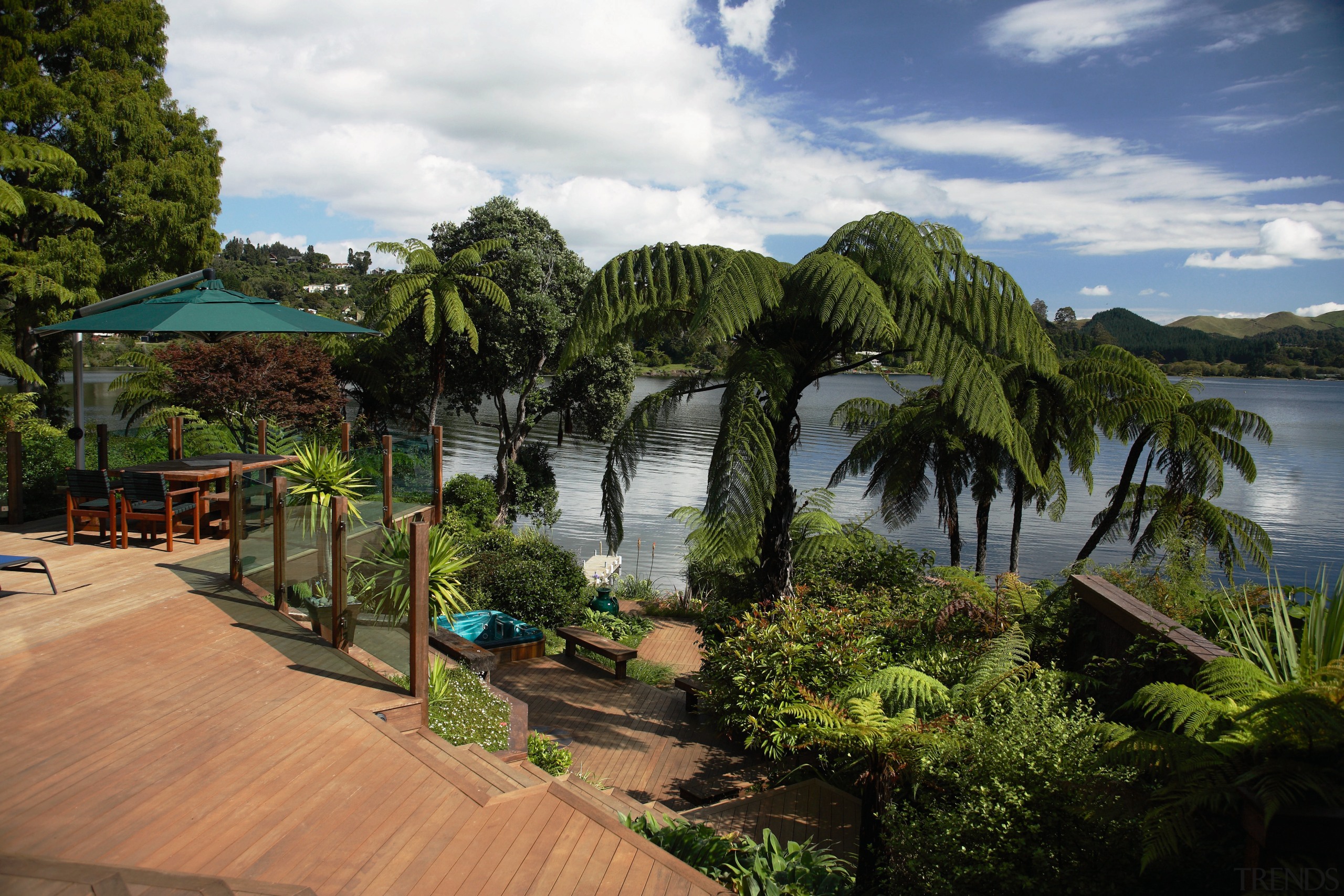 A view of some landscaping by LIANZ. - arecales, estate, leisure, palm tree, plant, real estate, resort, sky, tree, tropics, vegetation, water, brown