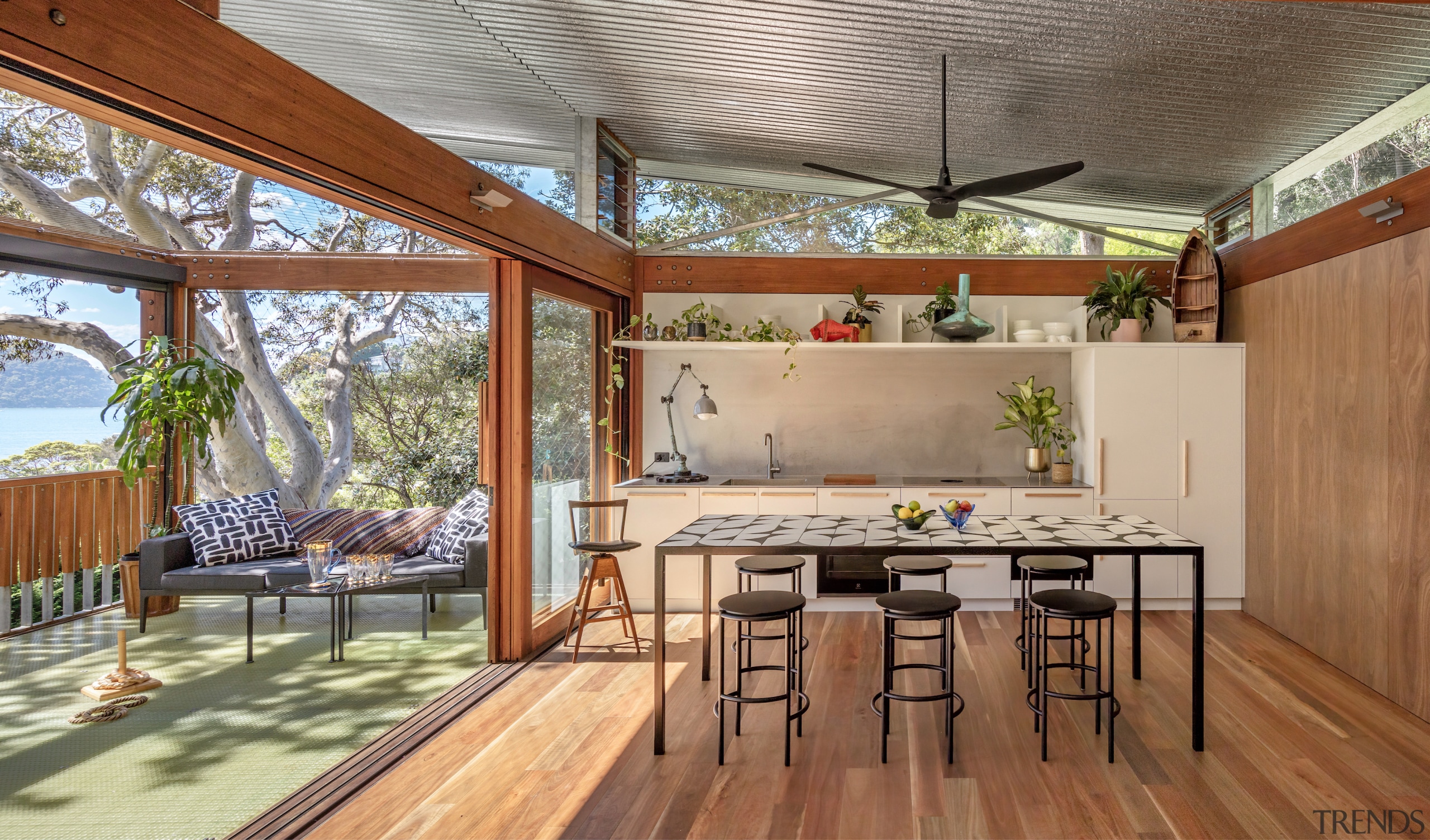 Kitchen, dining and deck showing over-arching architecture. Photography 