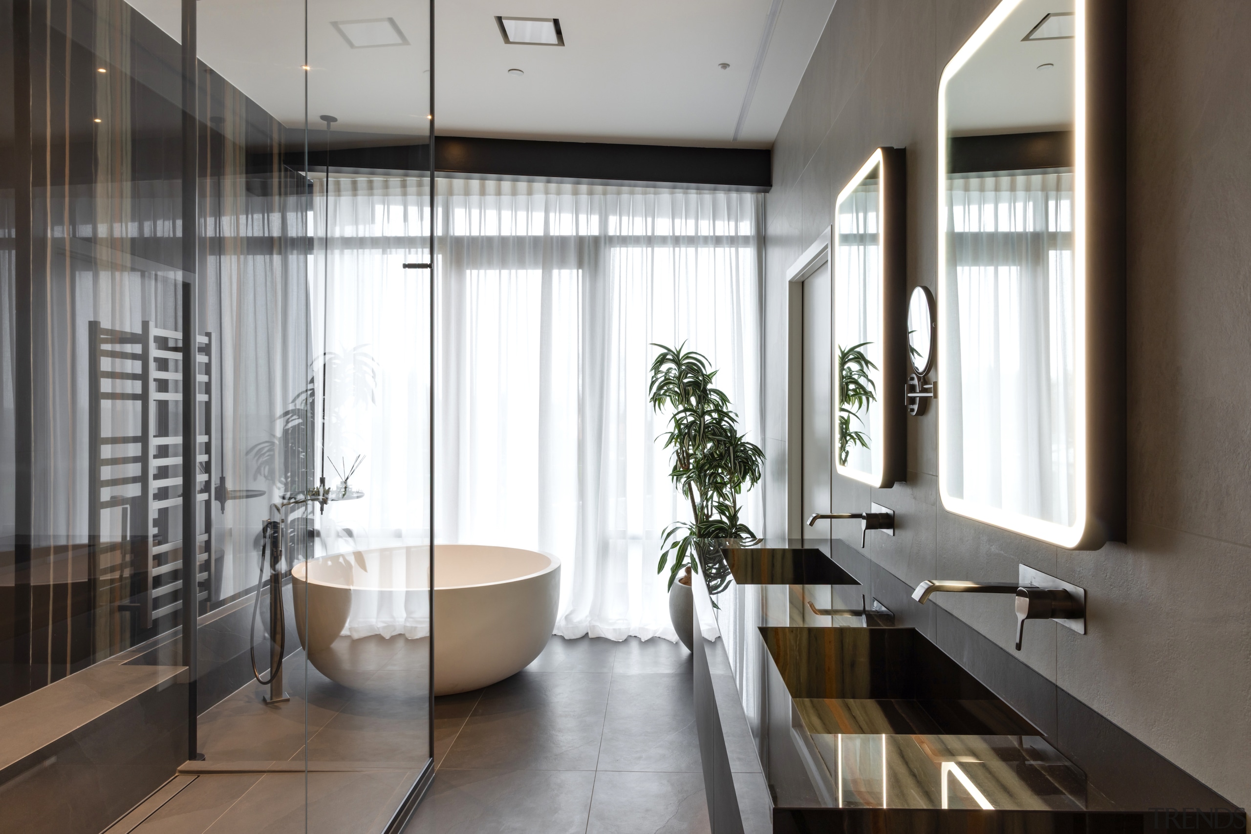 Master ensuite with circular tub  and diaphanous curtains. 