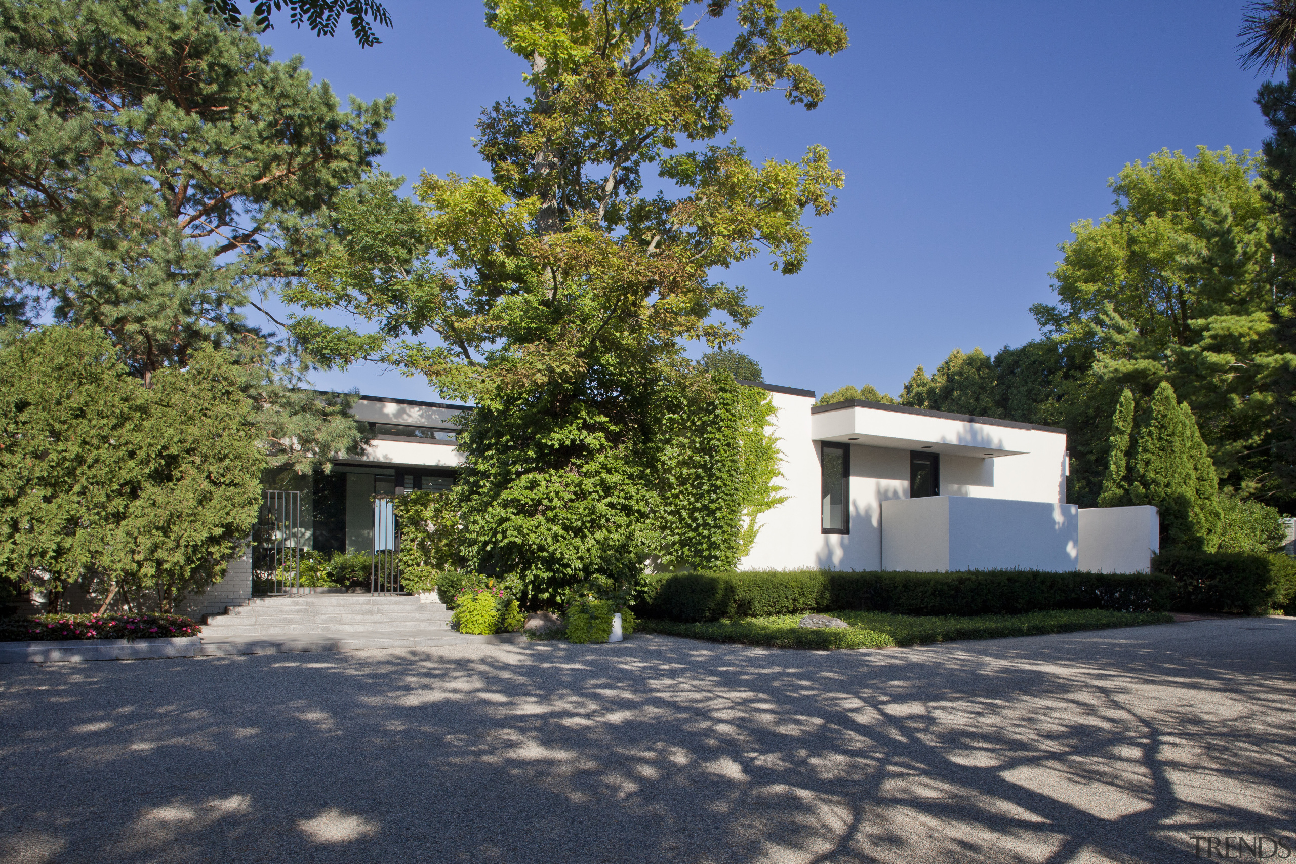 View of exterior in a 1970's house that architecture, cottage, estate, facade, home, house, landscape, neighbourhood, property, real estate, residential area, tree, villa, blue