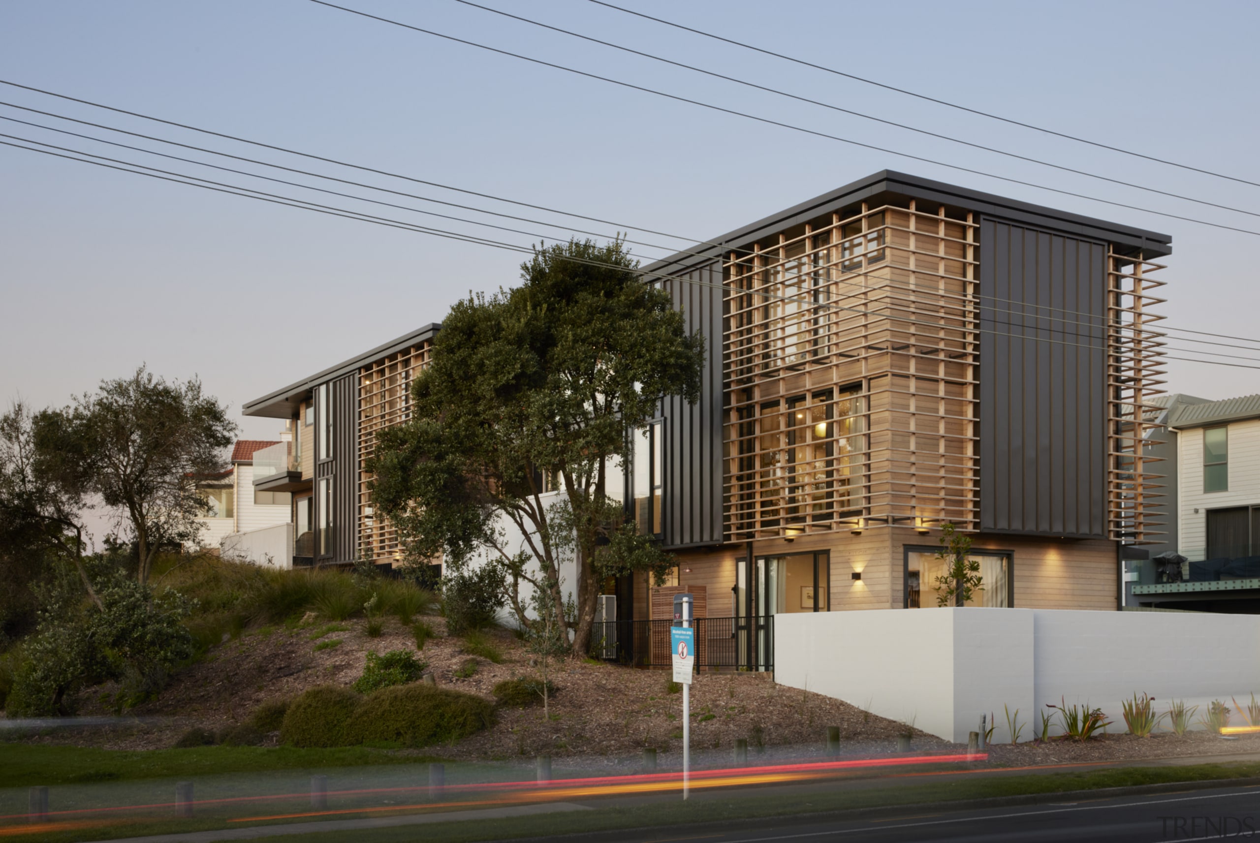 Cedar, coated steel, and concrete textures clad the 