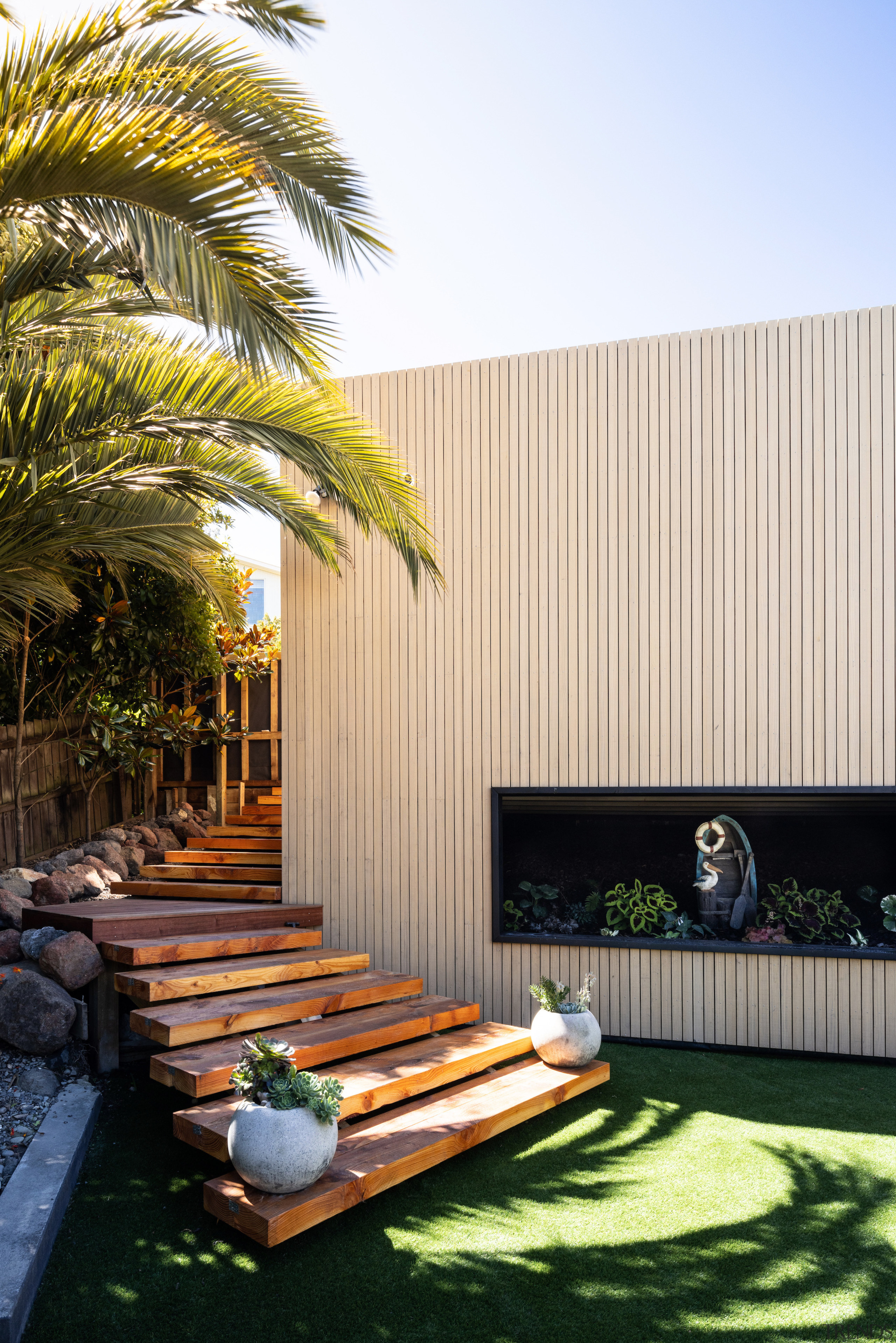 Courtyard with external stairwell and timber screen. 