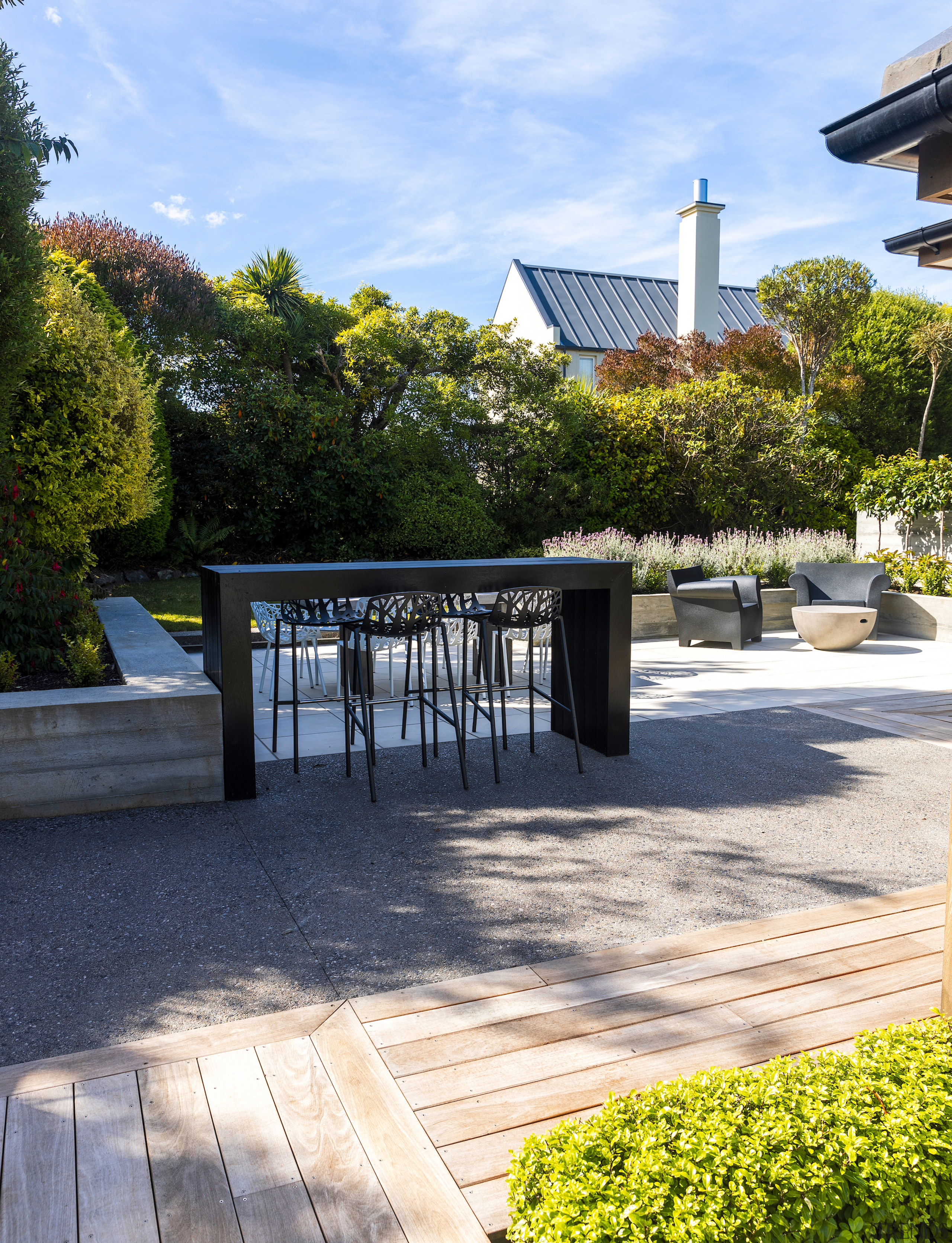 An outdoor bar leaner, outdoor table and seats 