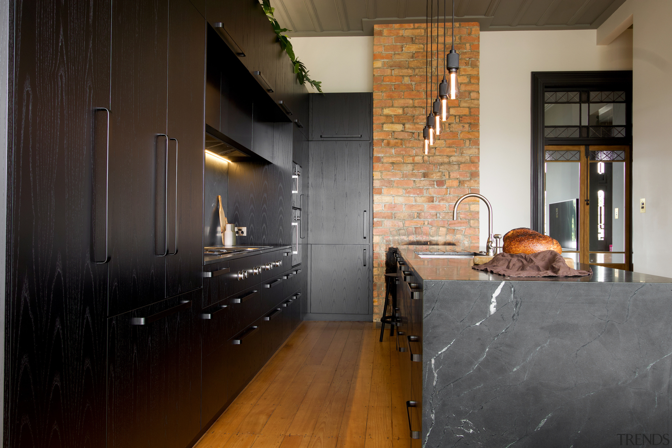 A bank of open-grain, dark-stained Ash timber cabinetry 