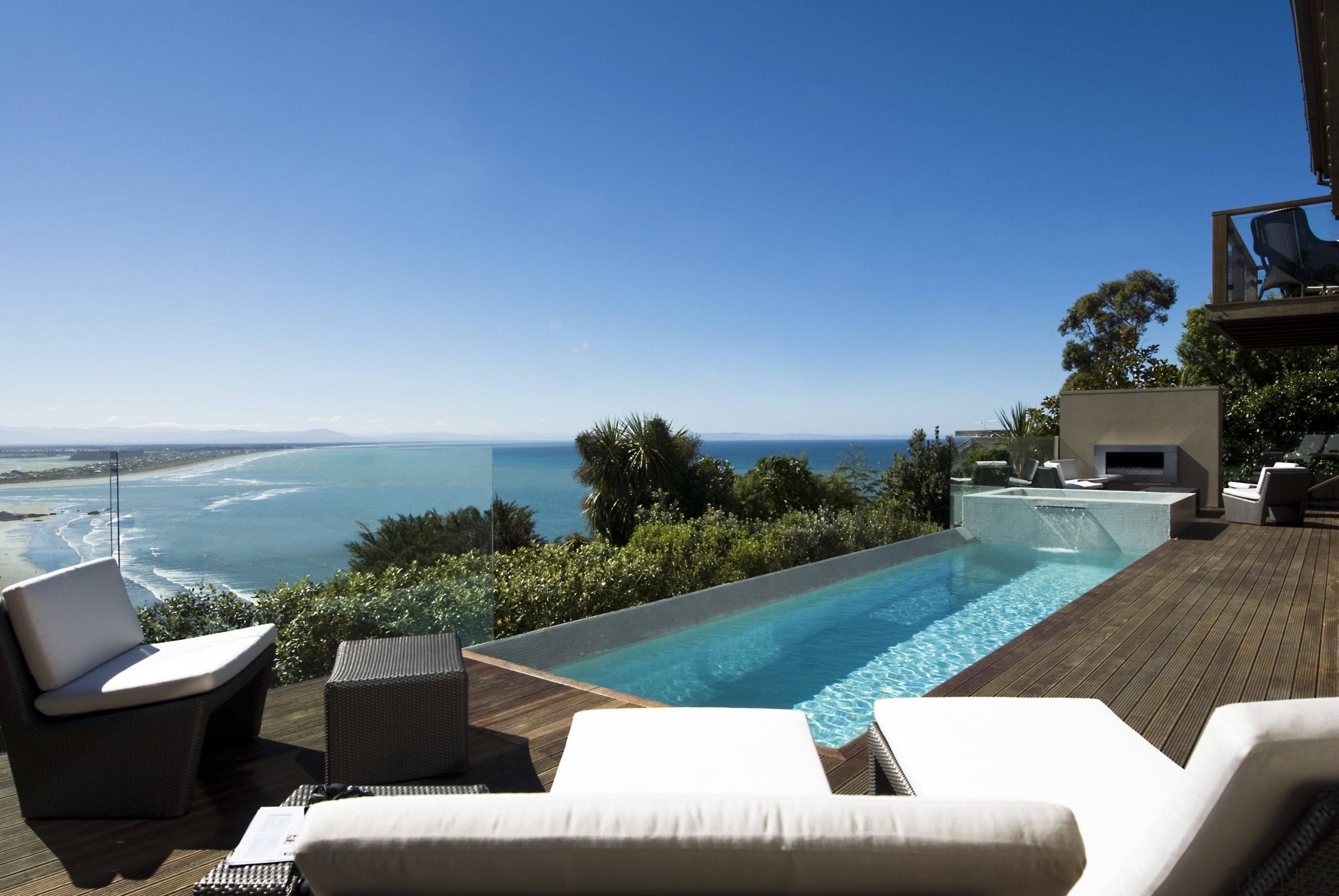 View of pool and spa area with wooden estate, home, house, leisure, penthouse apartment, property, real estate, resort, sea, sky, swimming pool, vacation, villa, teal