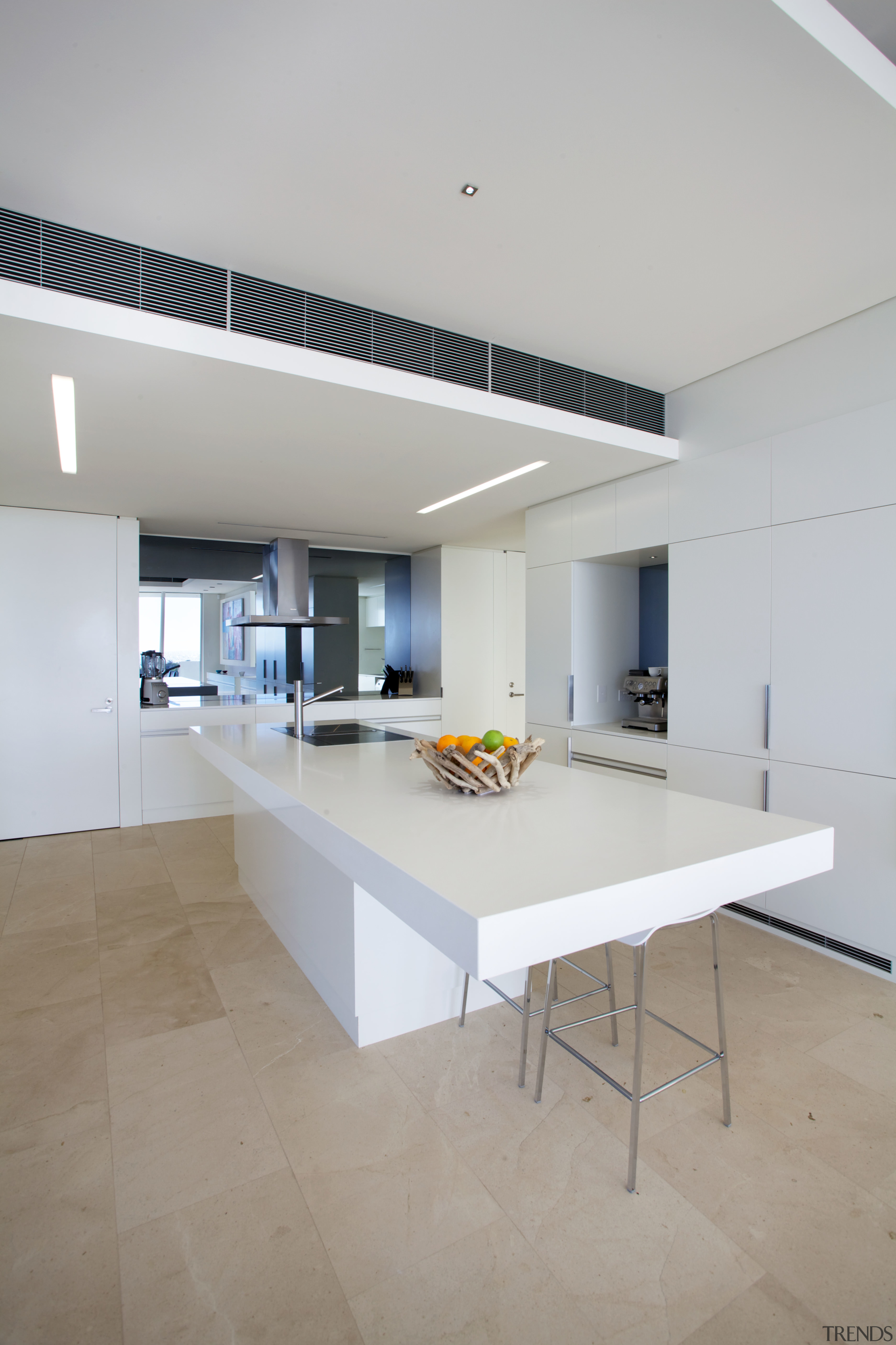 A grey mirror glass splashback reflects the ocean architecture, ceiling, countertop, daylighting, floor, flooring, house, interior design, kitchen, real estate, table, gray