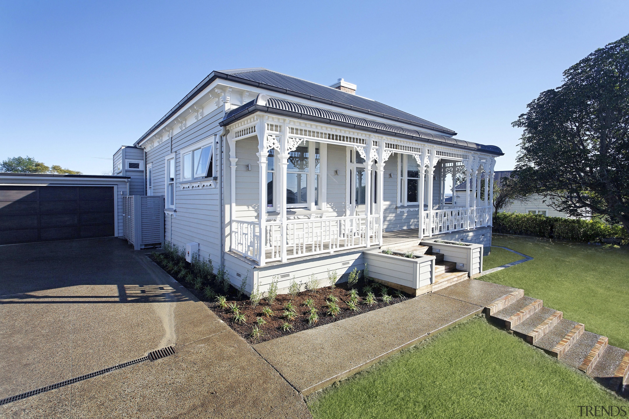 Exterior view of a villa-styled home which is cottage, estate, facade, farmhouse, home, house, property, real estate, villa, teal