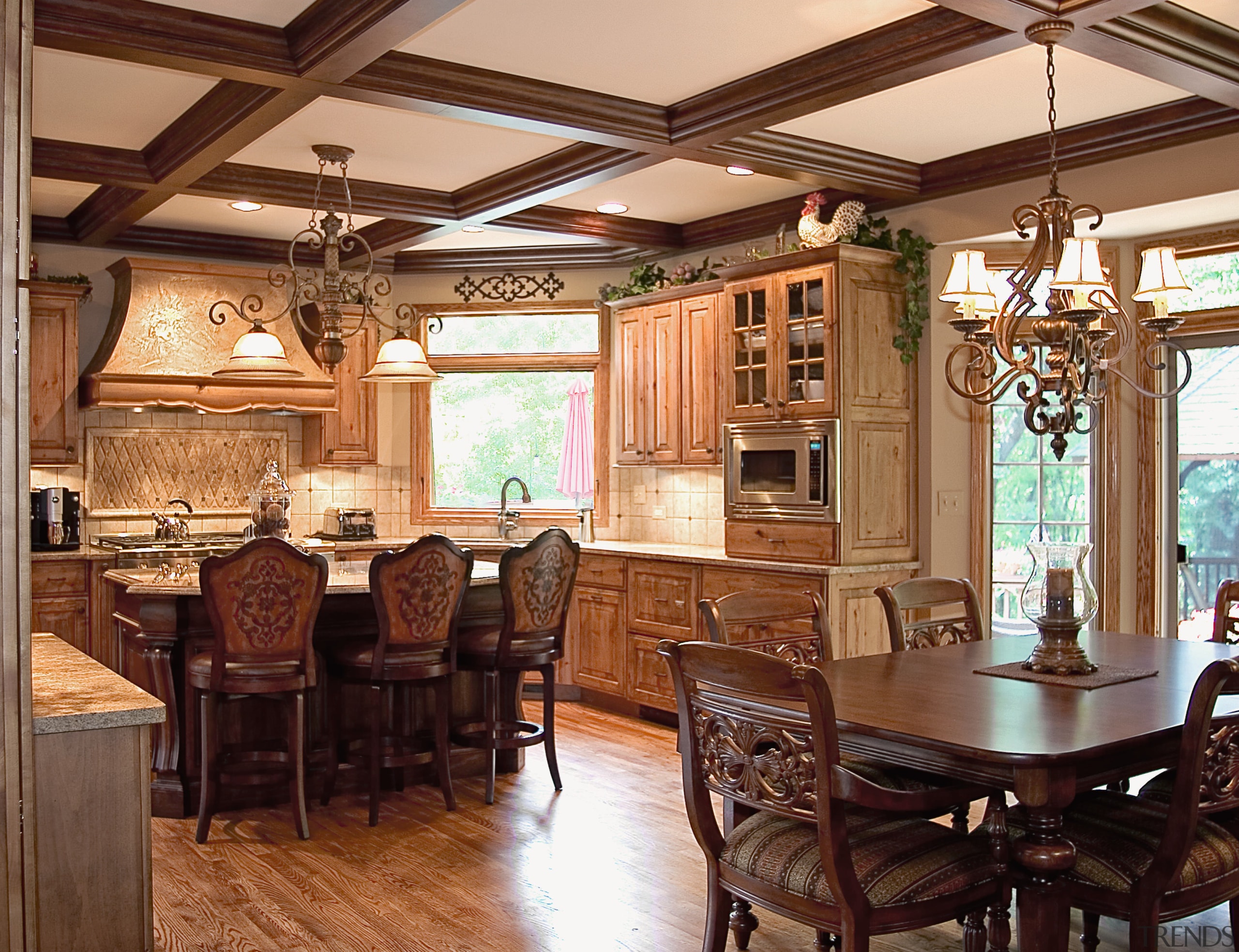 To provide the family with top-of-the-line cooking facilities, cabinetry, ceiling, dining room, furniture, interior design, kitchen, real estate, room, wood, brown