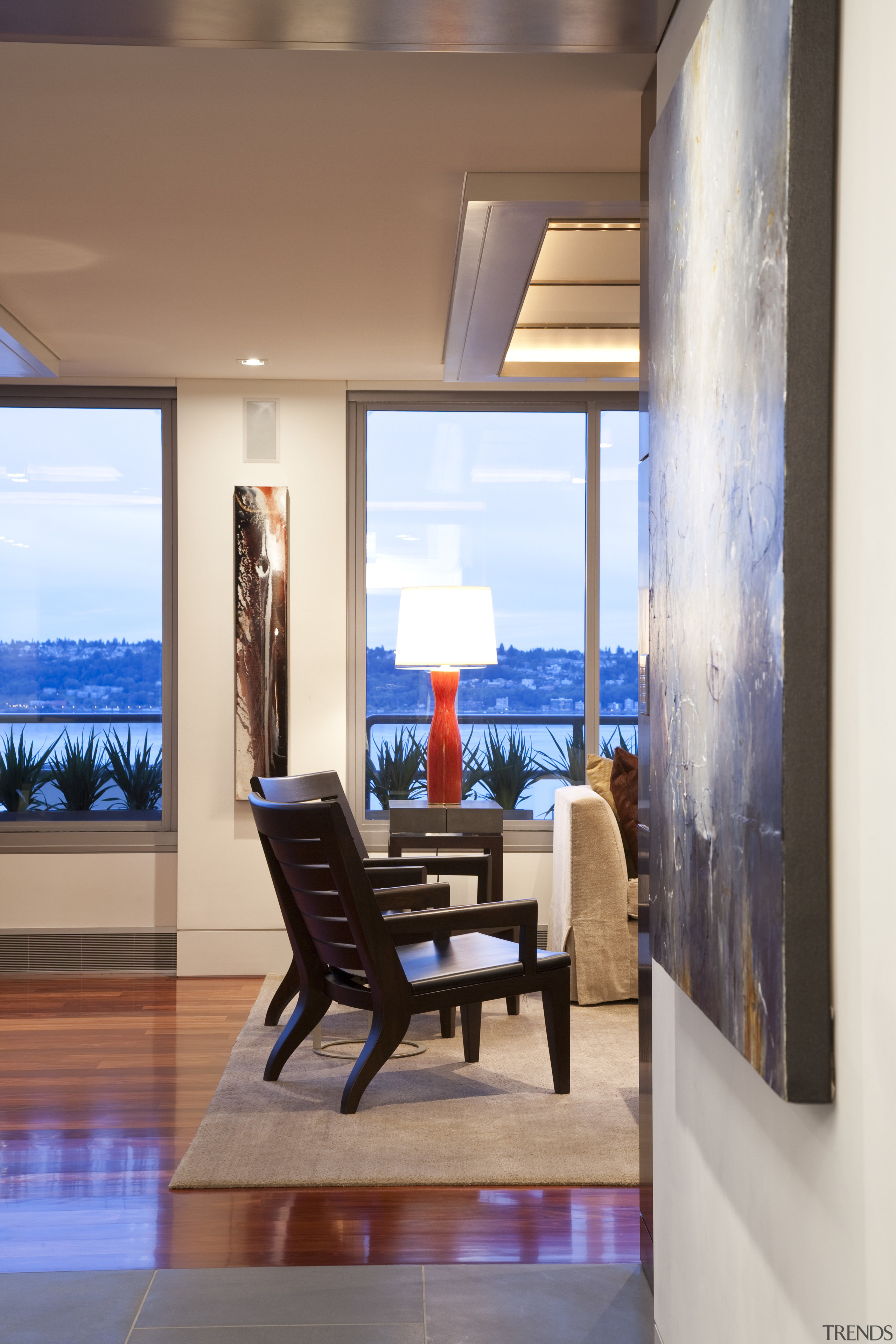 View from entrance hall featuring wood floors, artwork, ceiling, interior design, living room, window, white