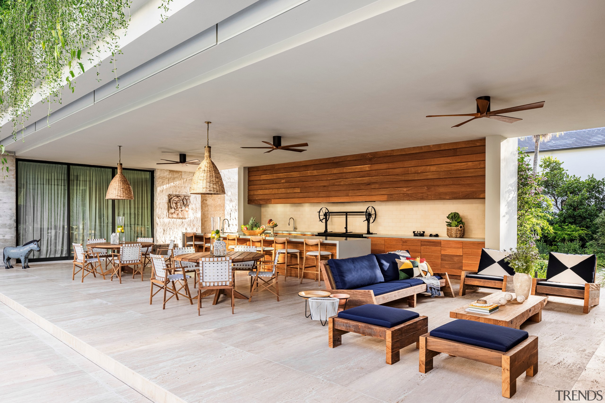 Unfilled travertine flooring crosses from the patio to 
