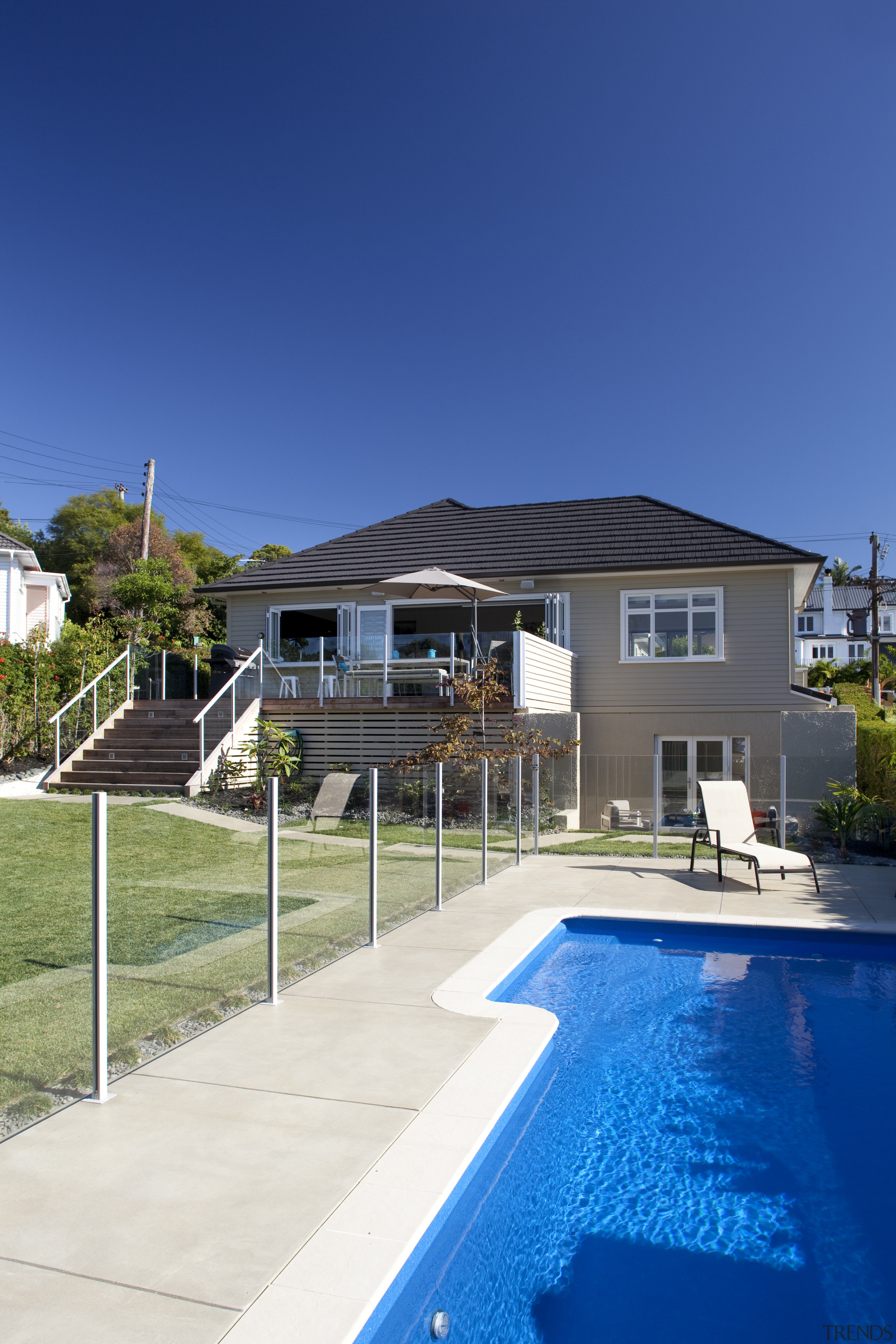 Exterior shot showing stairs down to lawn and architecture, backyard, cottage, elevation, estate, facade, home, house, leisure, property, real estate, residential area, resort, sky, suburb, swimming pool, villa, blue