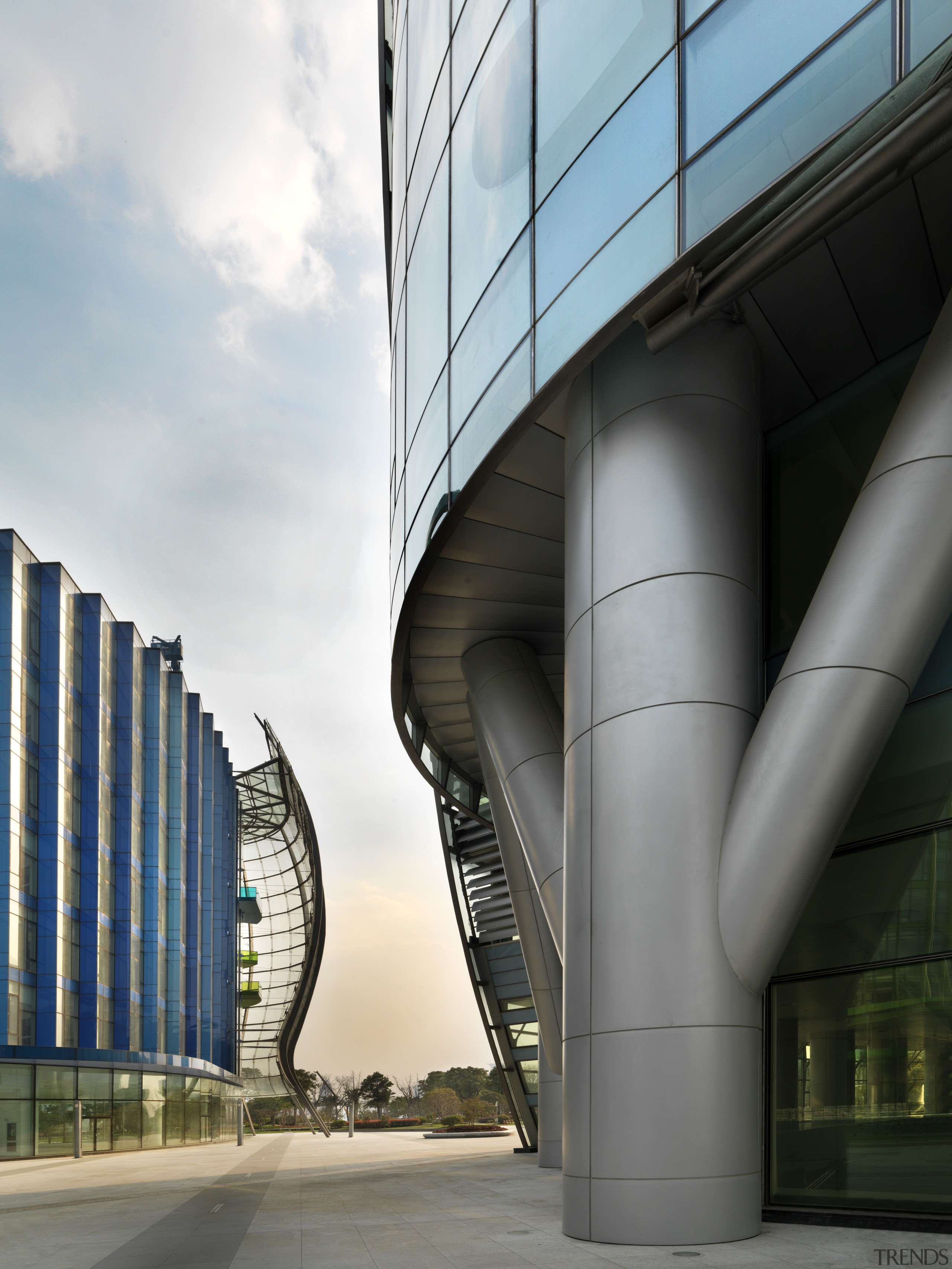 View of the Shanghai International Cruise Terminal. architecture, building, corporate headquarters, daytime, facade, fixed link, headquarters, landmark, metropolis, metropolitan area, sky, skyscraper, structure, tower block, urban area, gray, black