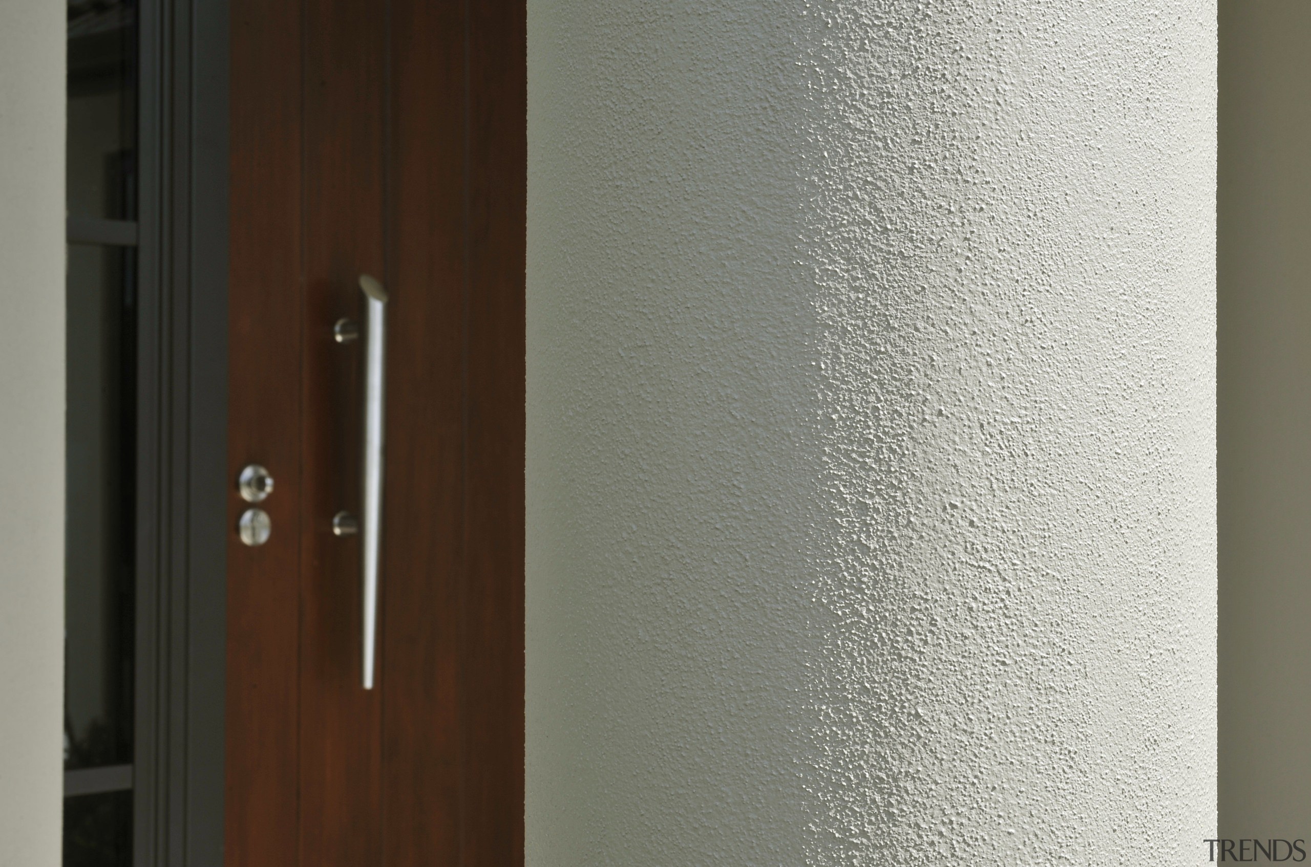 View of exterior cladding on a David Reid door, wall, wood, wood stain, gray