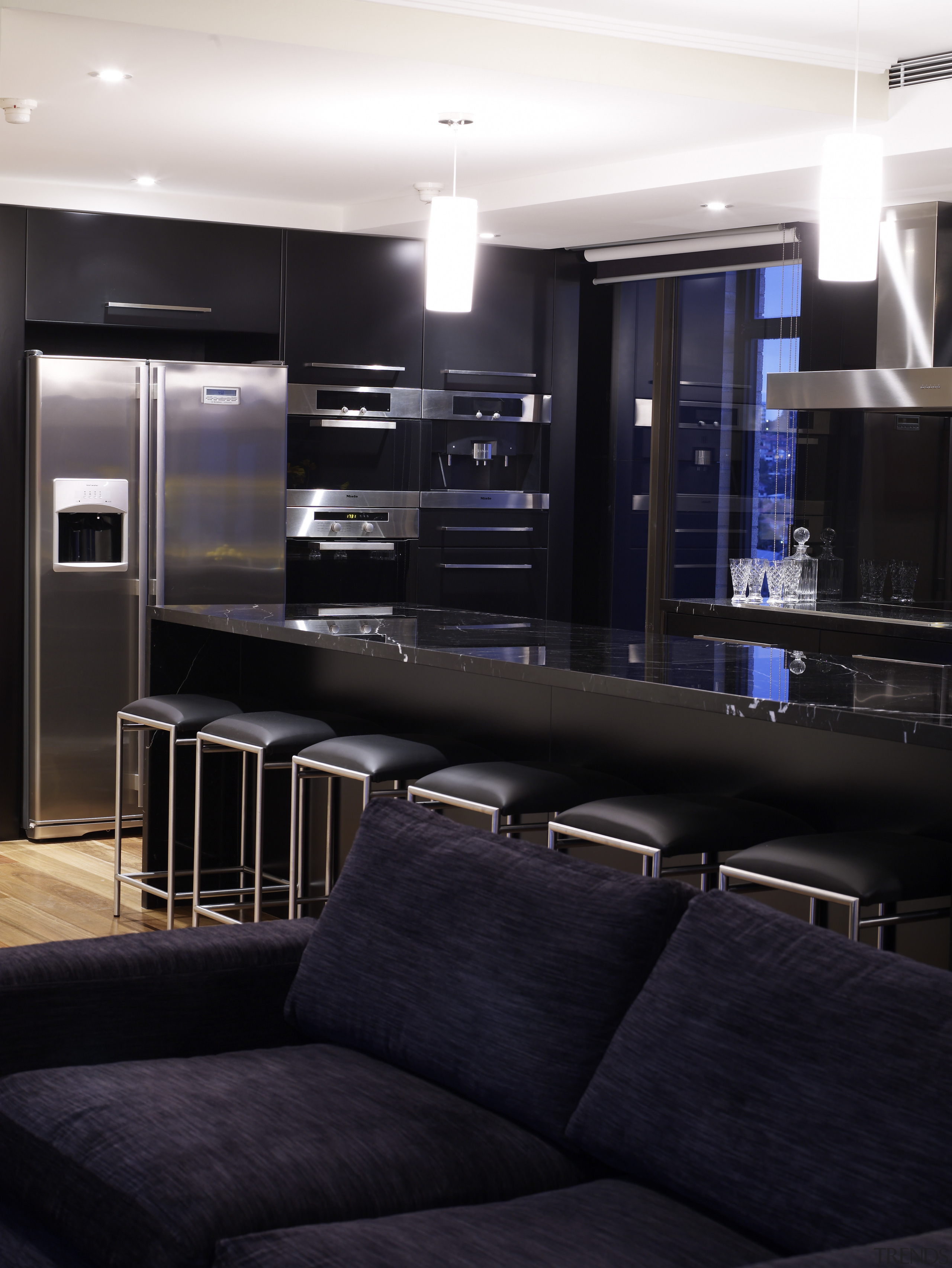 View of an apartment kitchen which features solid interior design, lighting, living room, black