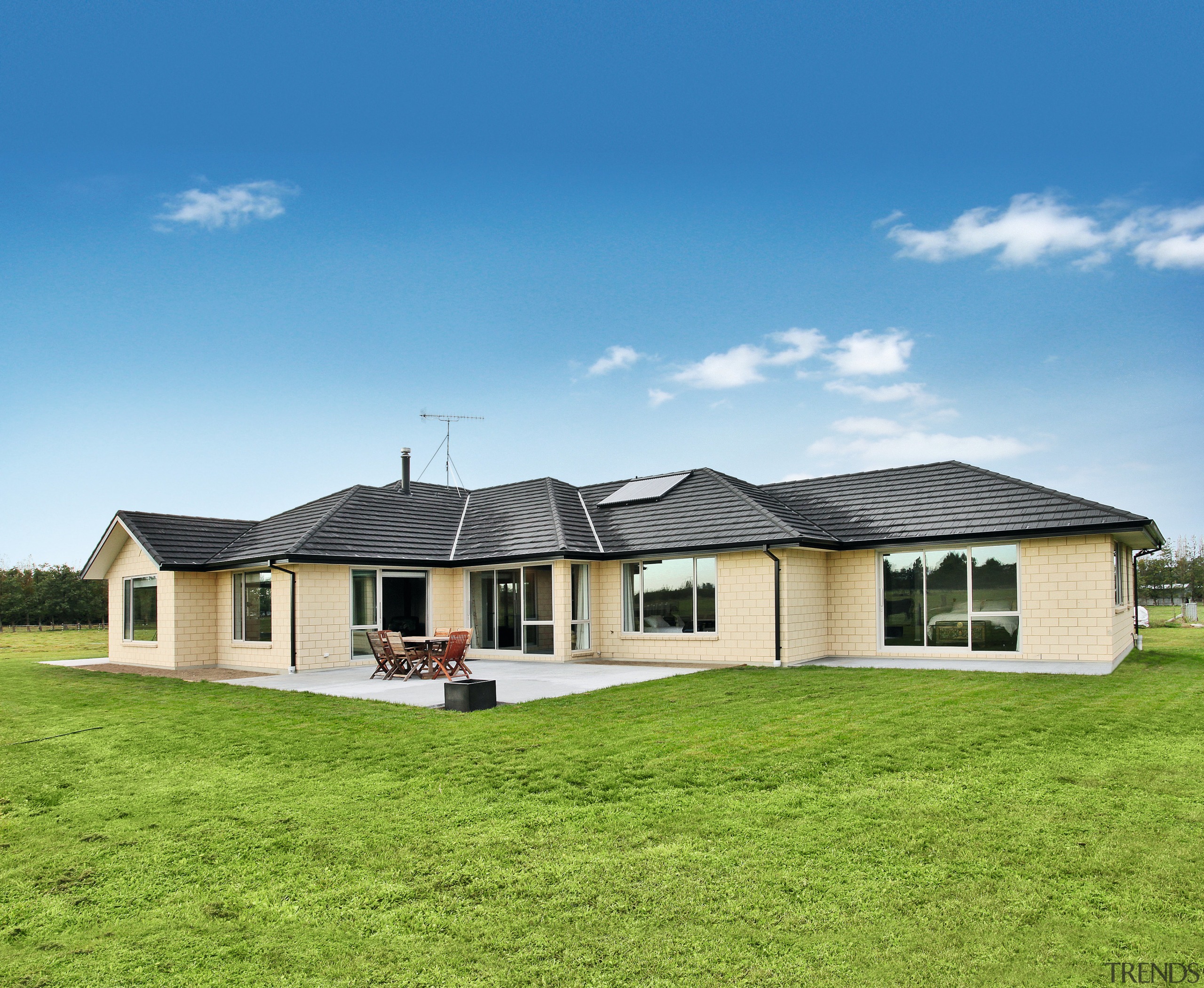 This kiln-fired clay brick-clad residence took out the cottage, elevation, estate, facade, farmhouse, grass, home, house, land lot, landscape, property, real estate, residential area, roof, sky, teal, green