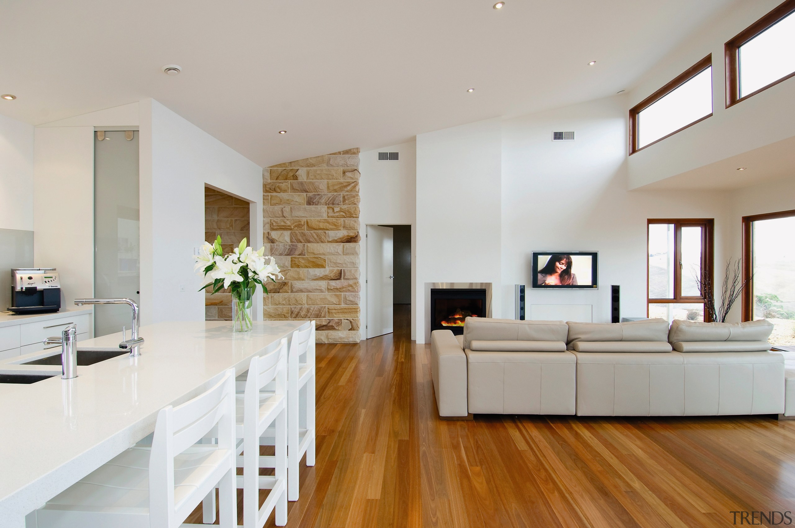View of the lounge and kitchen areas of ceiling, floor, flooring, hardwood, home, house, interior design, interior designer, laminate flooring, living room, property, real estate, room, wood flooring, gray