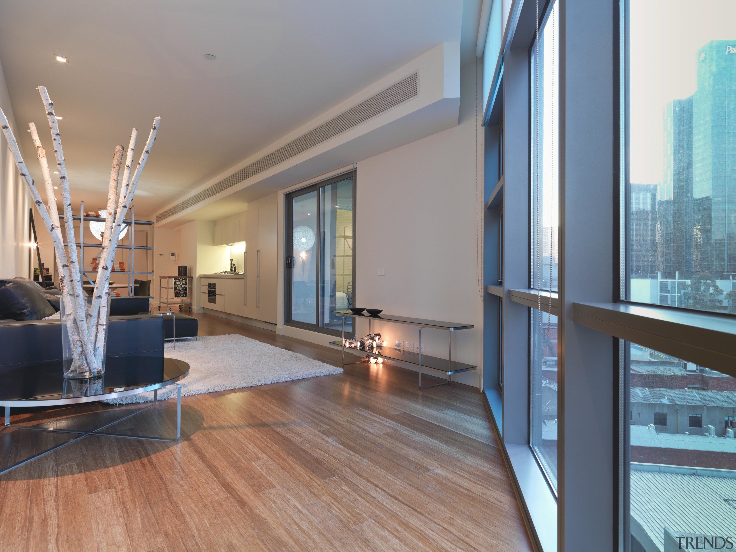 View the lounge area of an apartment at apartment, architecture, ceiling, condominium, daylighting, estate, floor, flooring, hardwood, interior design, living room, loft, penthouse apartment, property, real estate, window, wood, wood flooring, gray